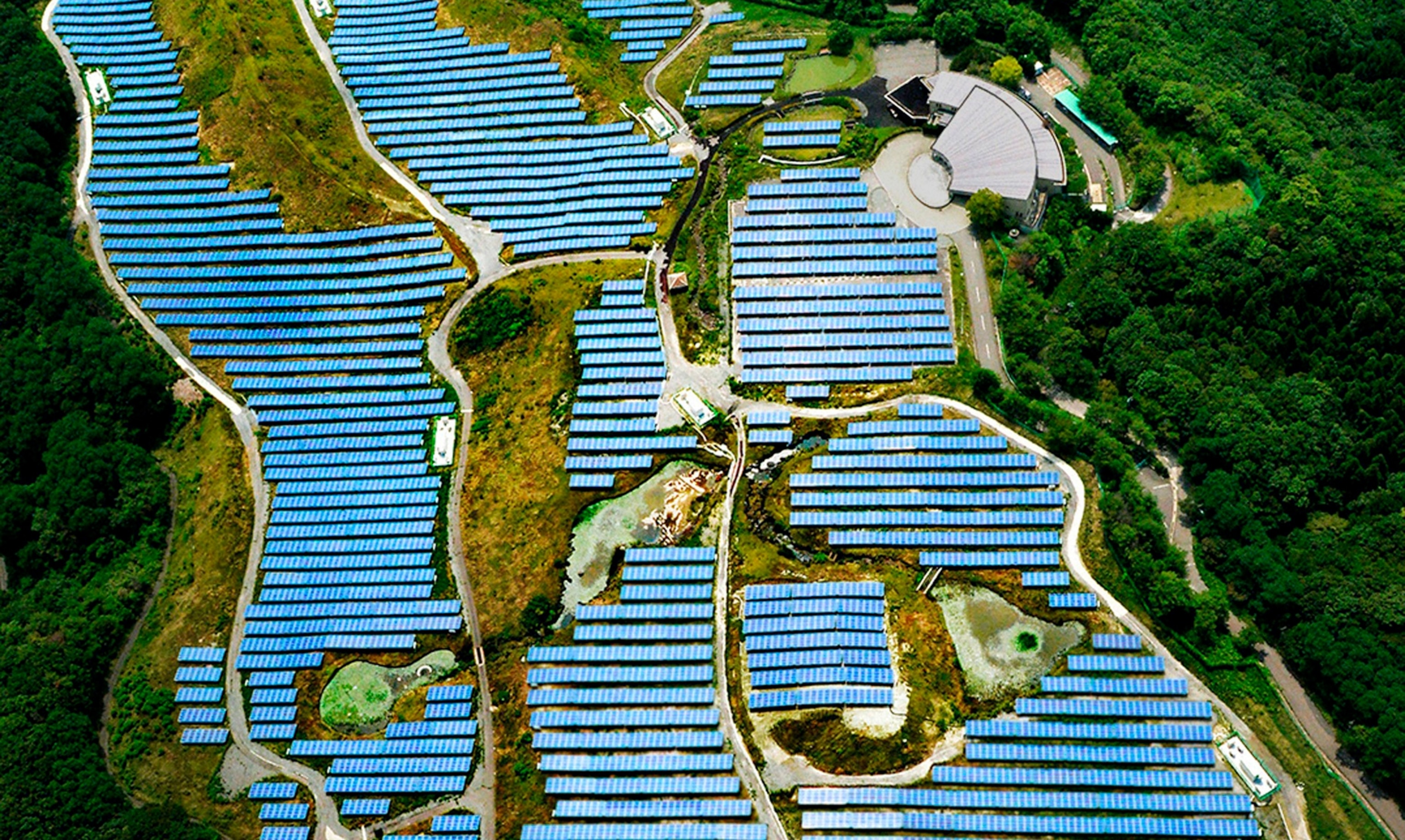 Arian view of blue zone between green hills.