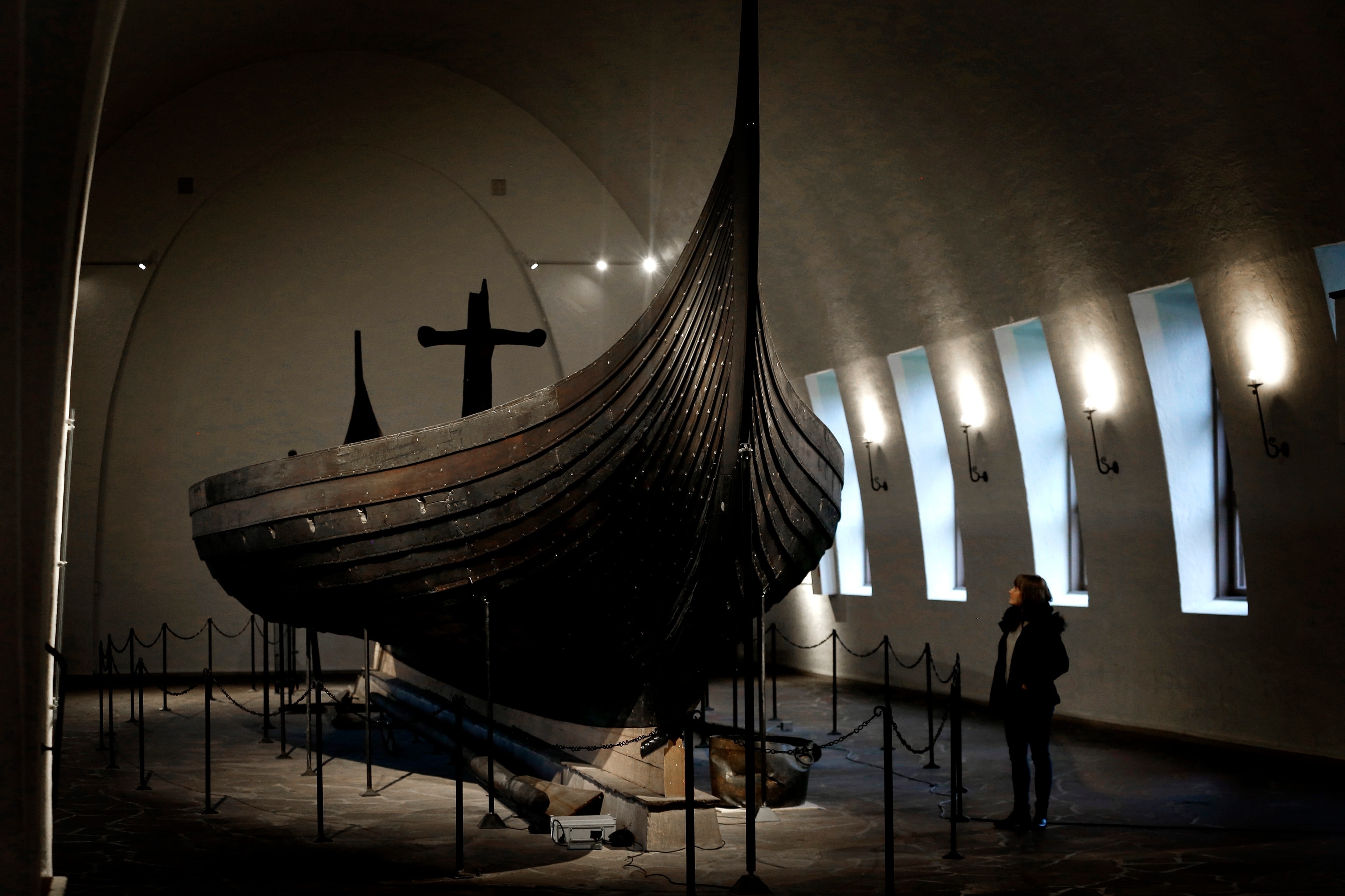 A large ship in a building with someone looking at it