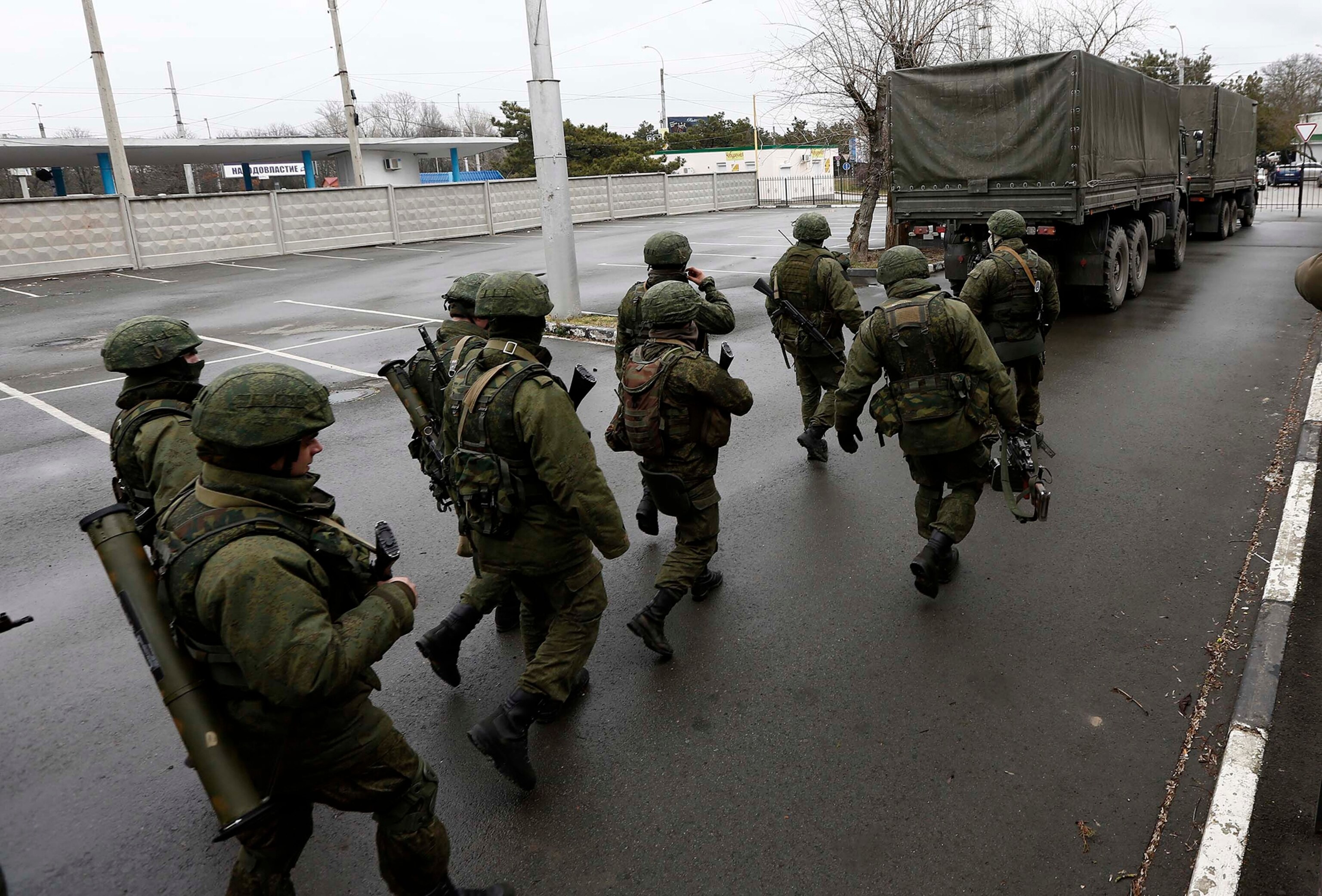 Unidentified armed men patrol outside of Simferopol airport, on February 28, 2014.