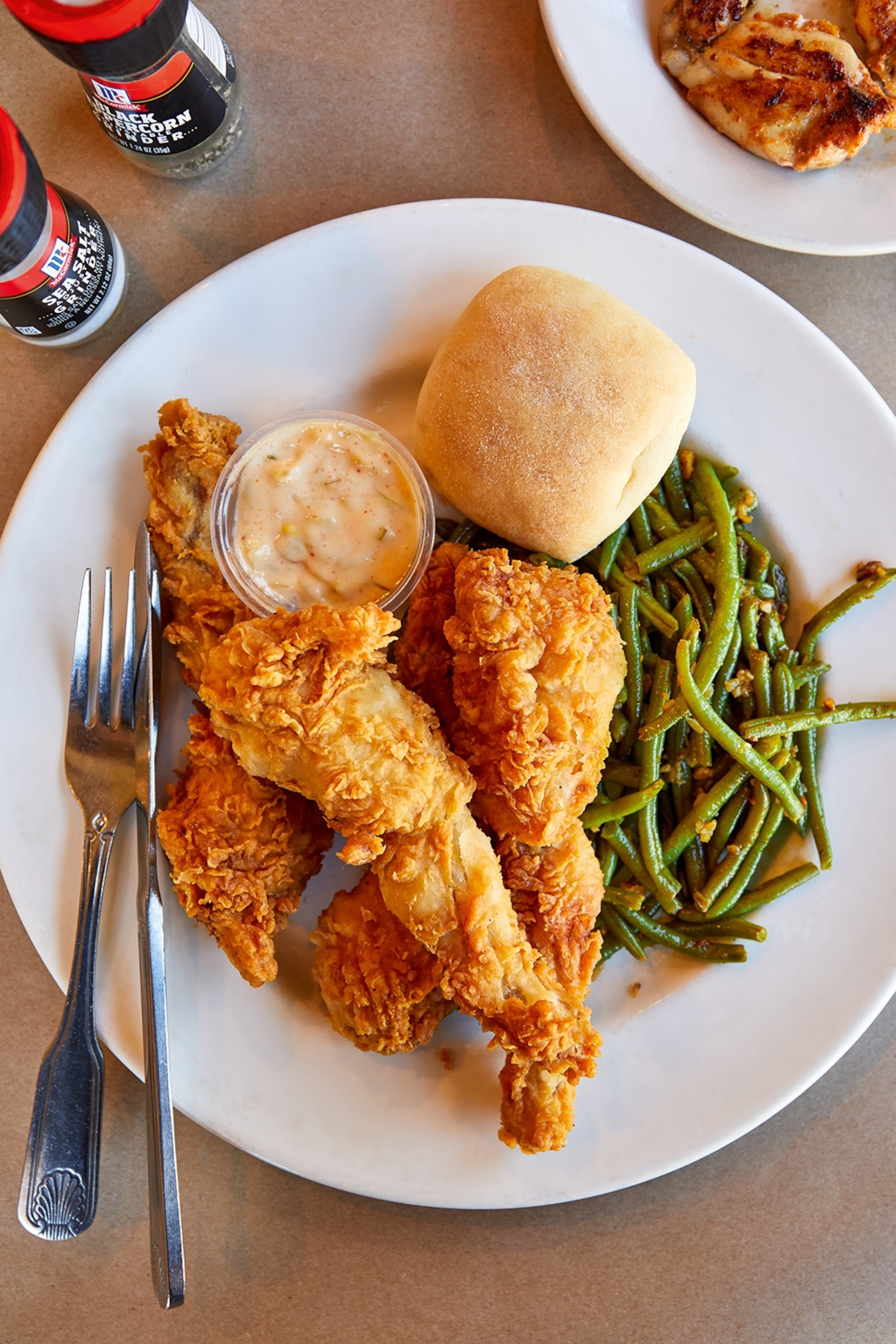 A plate of fried frog legs with green beans.