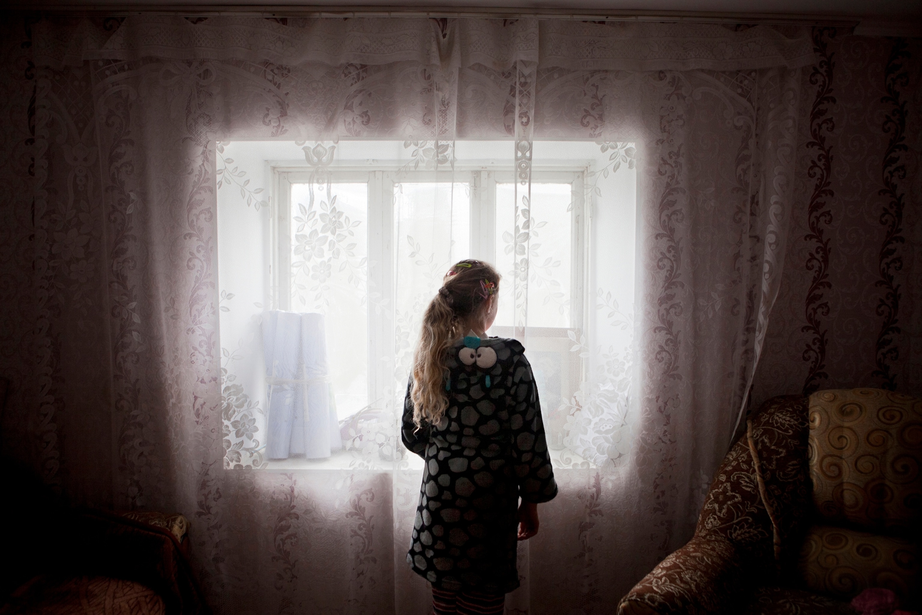 girl looking out windwo