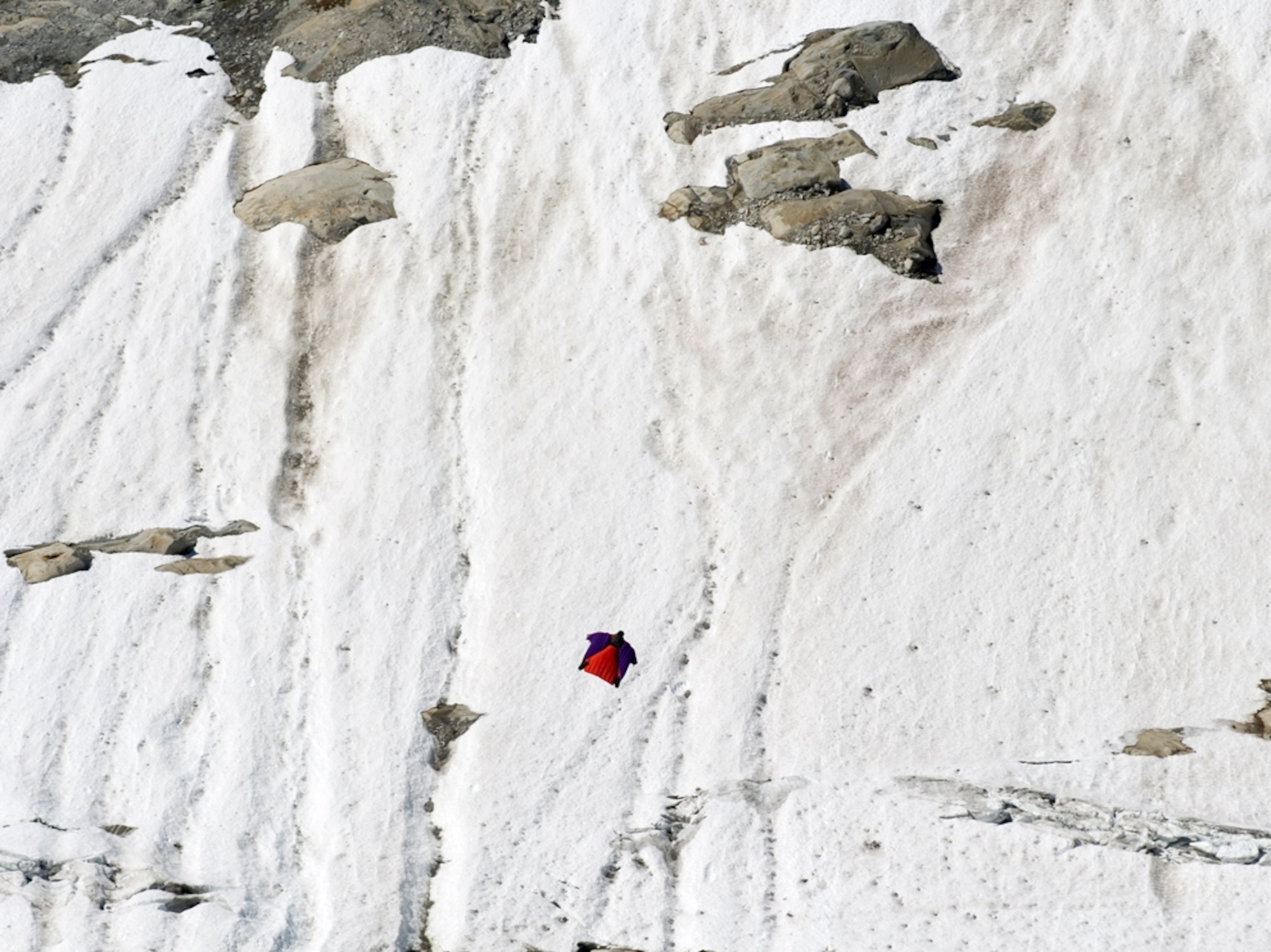 Dean Potter flying in a wingsuit above Mt. Butte in British Columbia