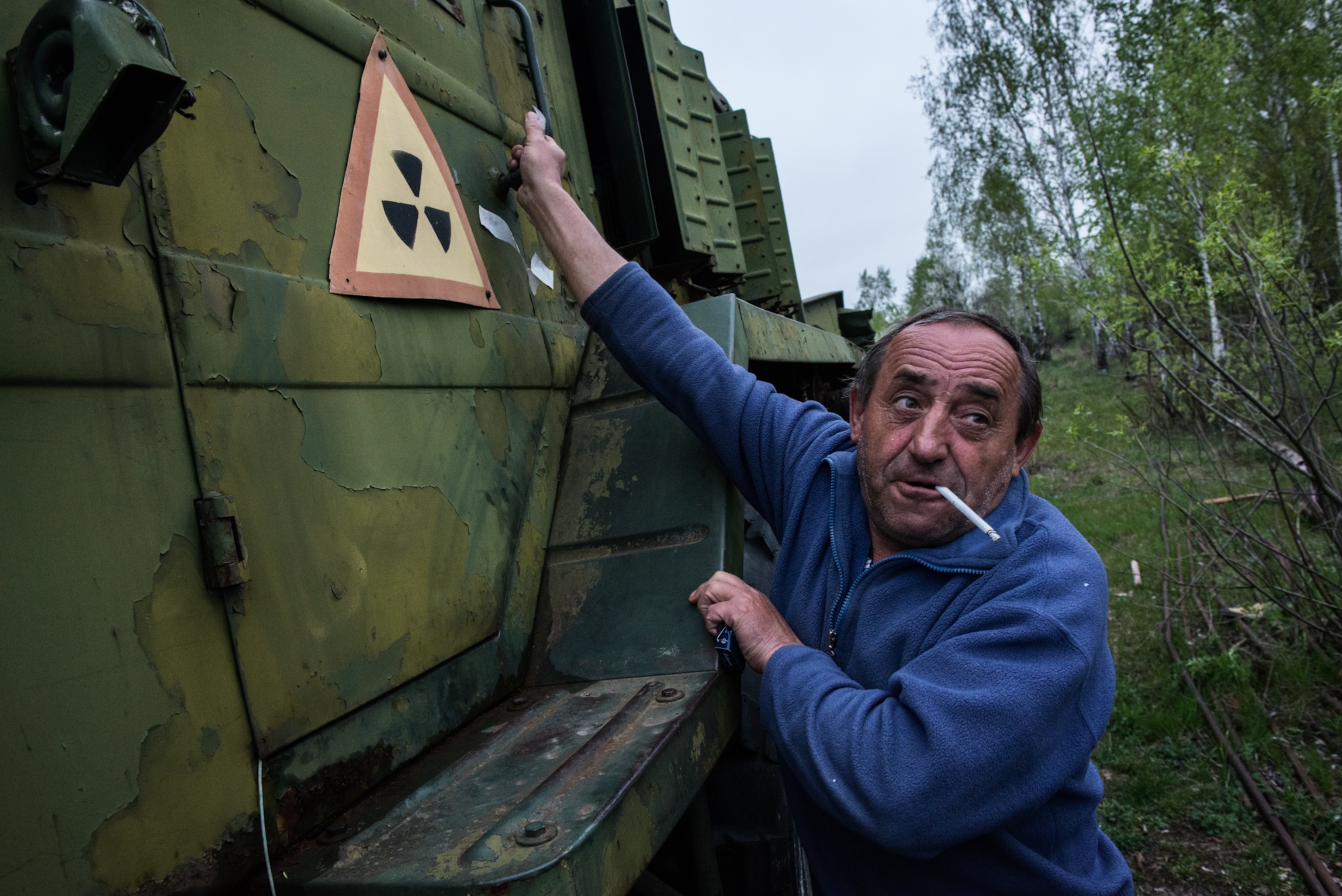 A fireman with his fire engine on a fire station inside the Chernobyl Exclusion Zone.
