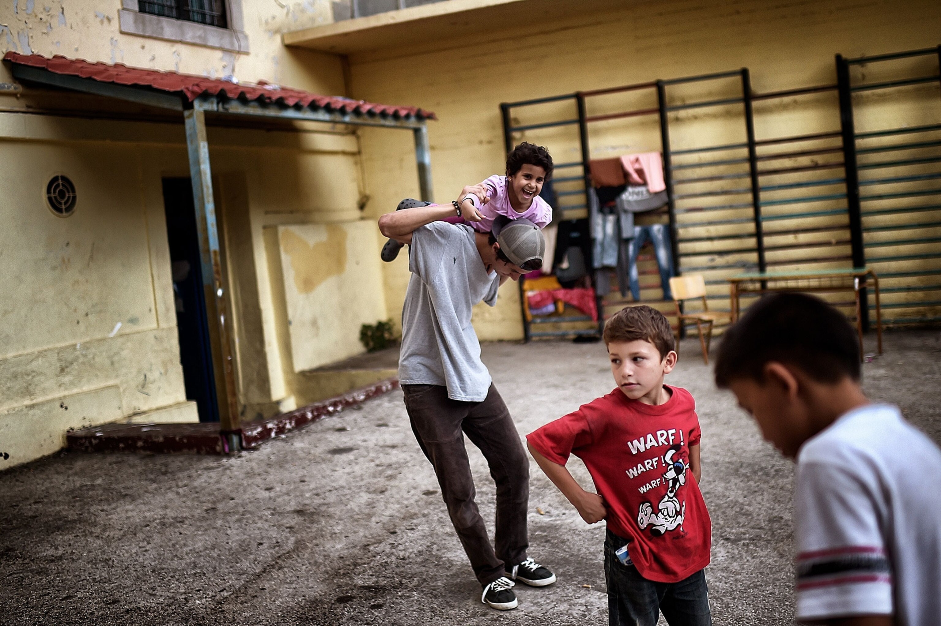 children playing in a school courtyard in Athens