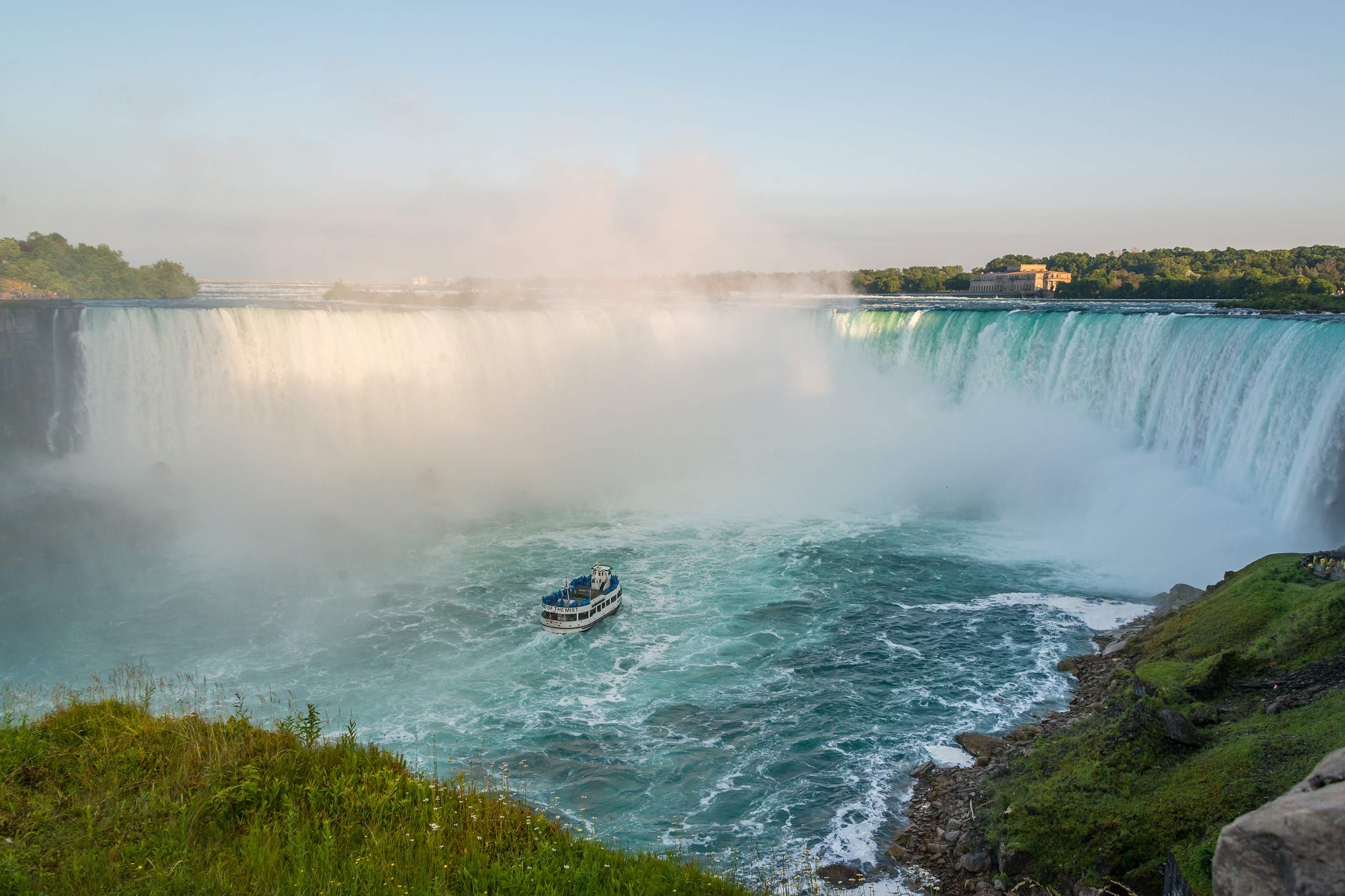 The Niagara Falls with a boot anchored right in front of the waterfalls.