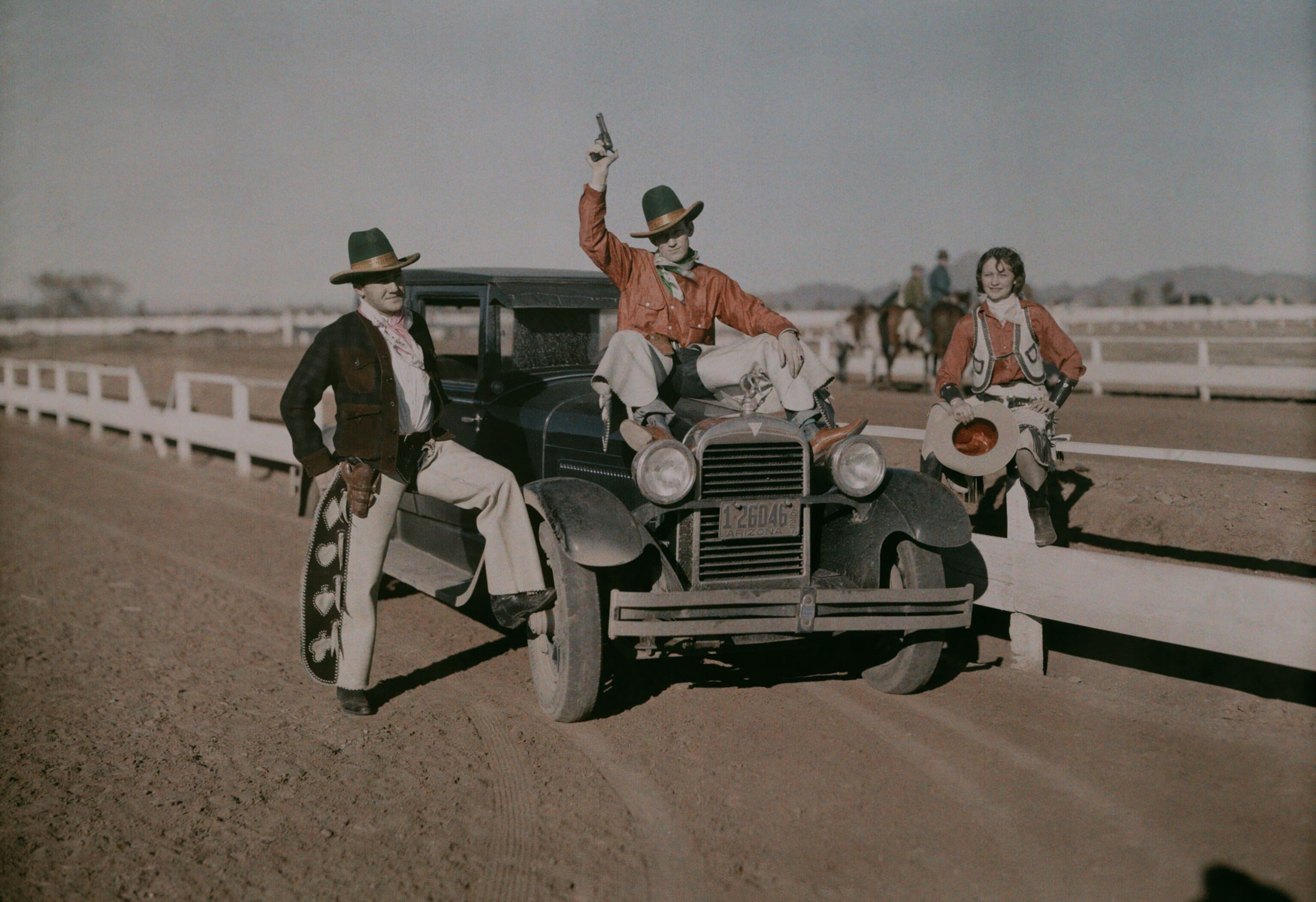 the Jaycees posing on a car for a benefit rodeo