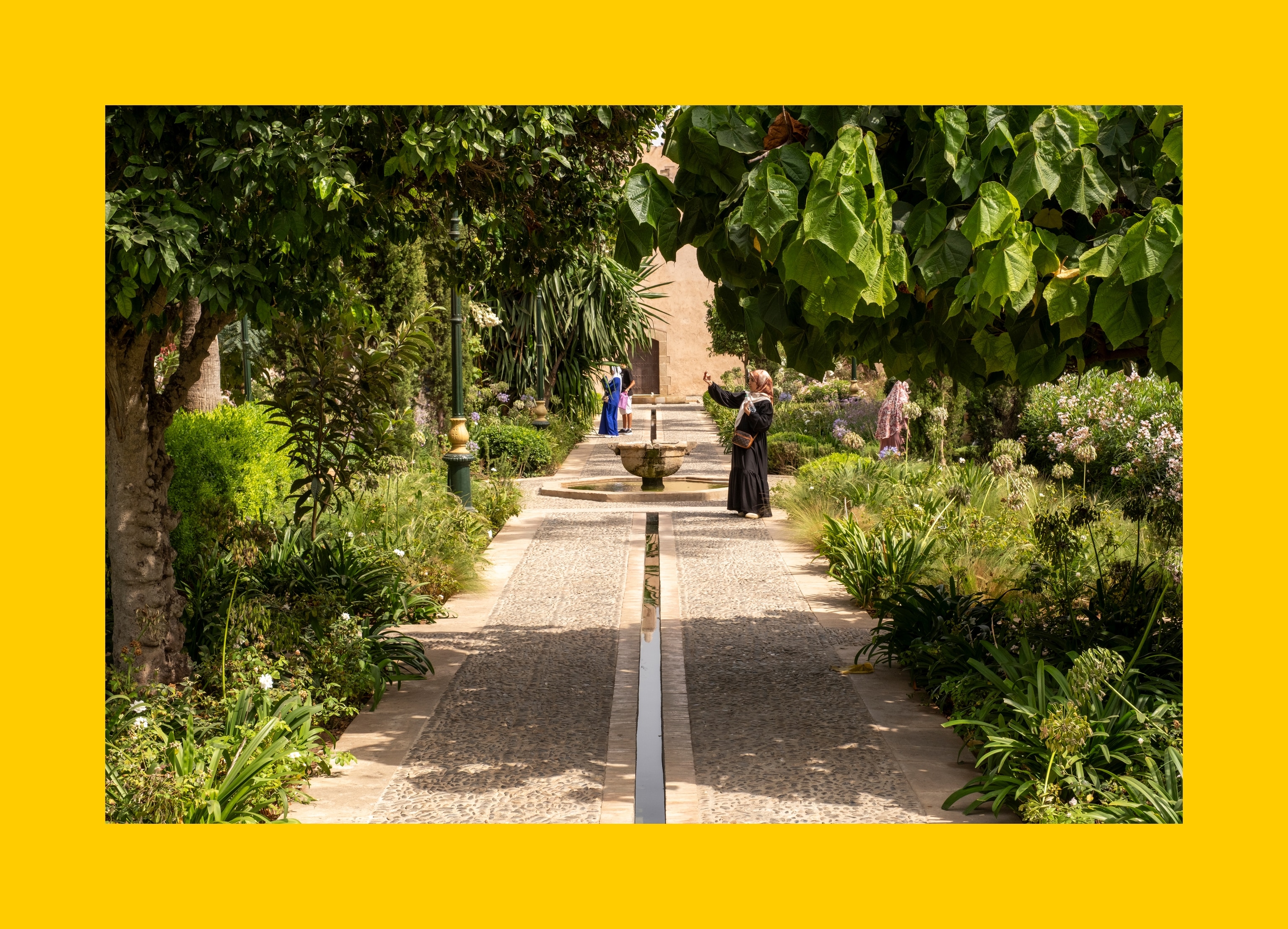 Andalusian garden in the Kasbah of the Oudayas, where lush greenery, fragrant orange trees, and moorish design create a peaceful oasis in the heart of Rabat for walkers to enjoy.