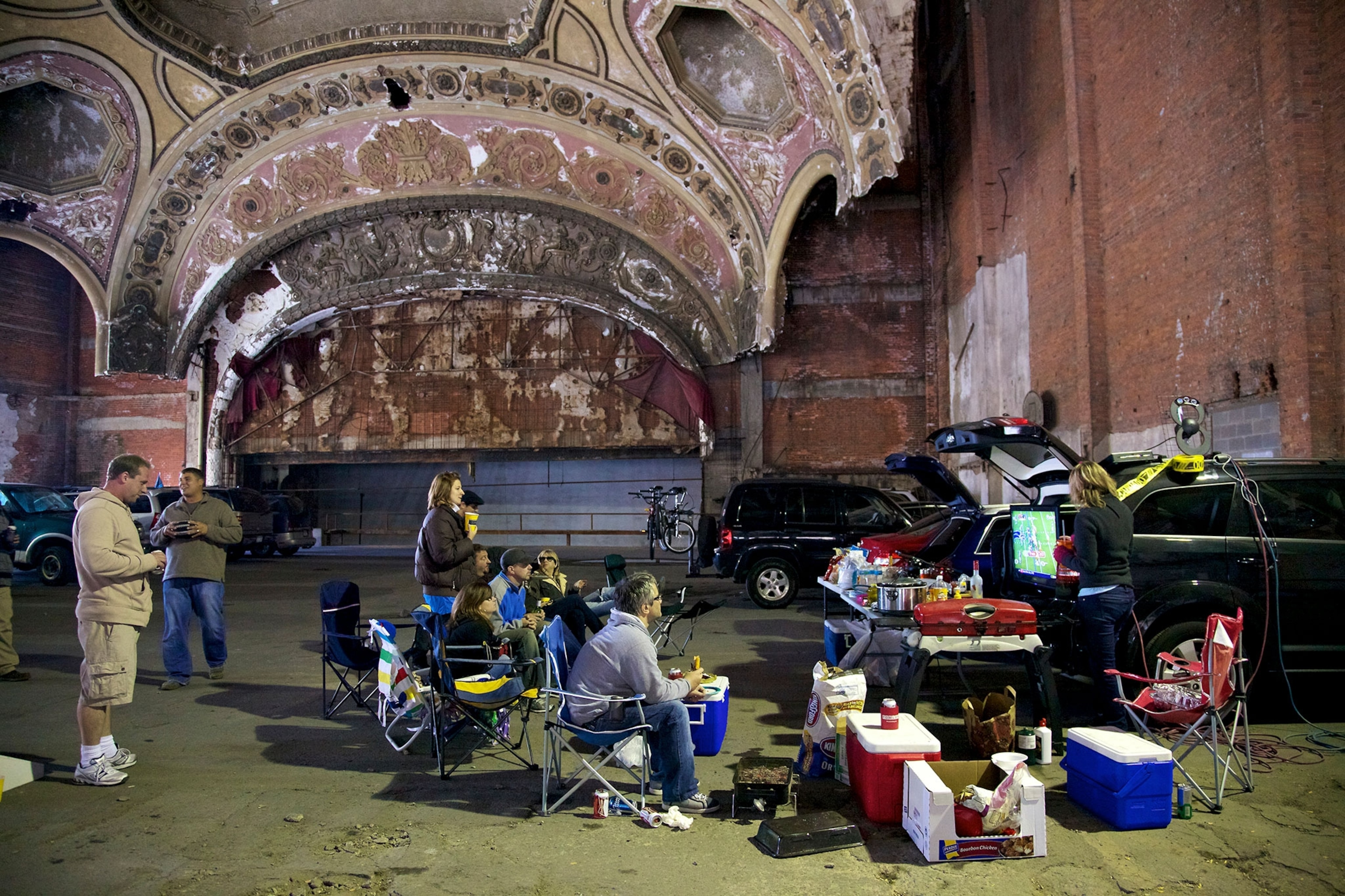tailgaters watching a Lions game on TV