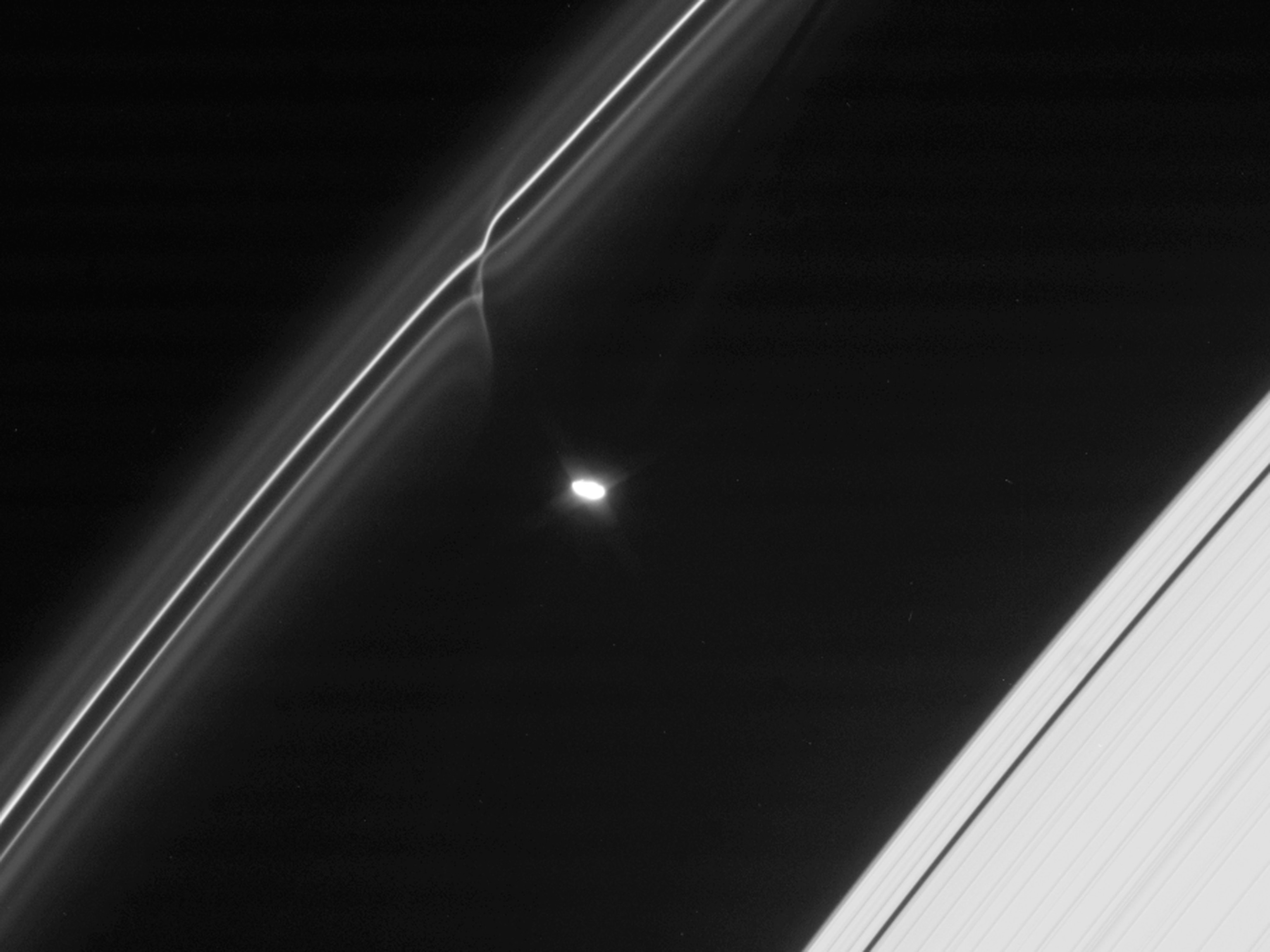 Saturn picture: an icy ball punching through one of the planet's rings