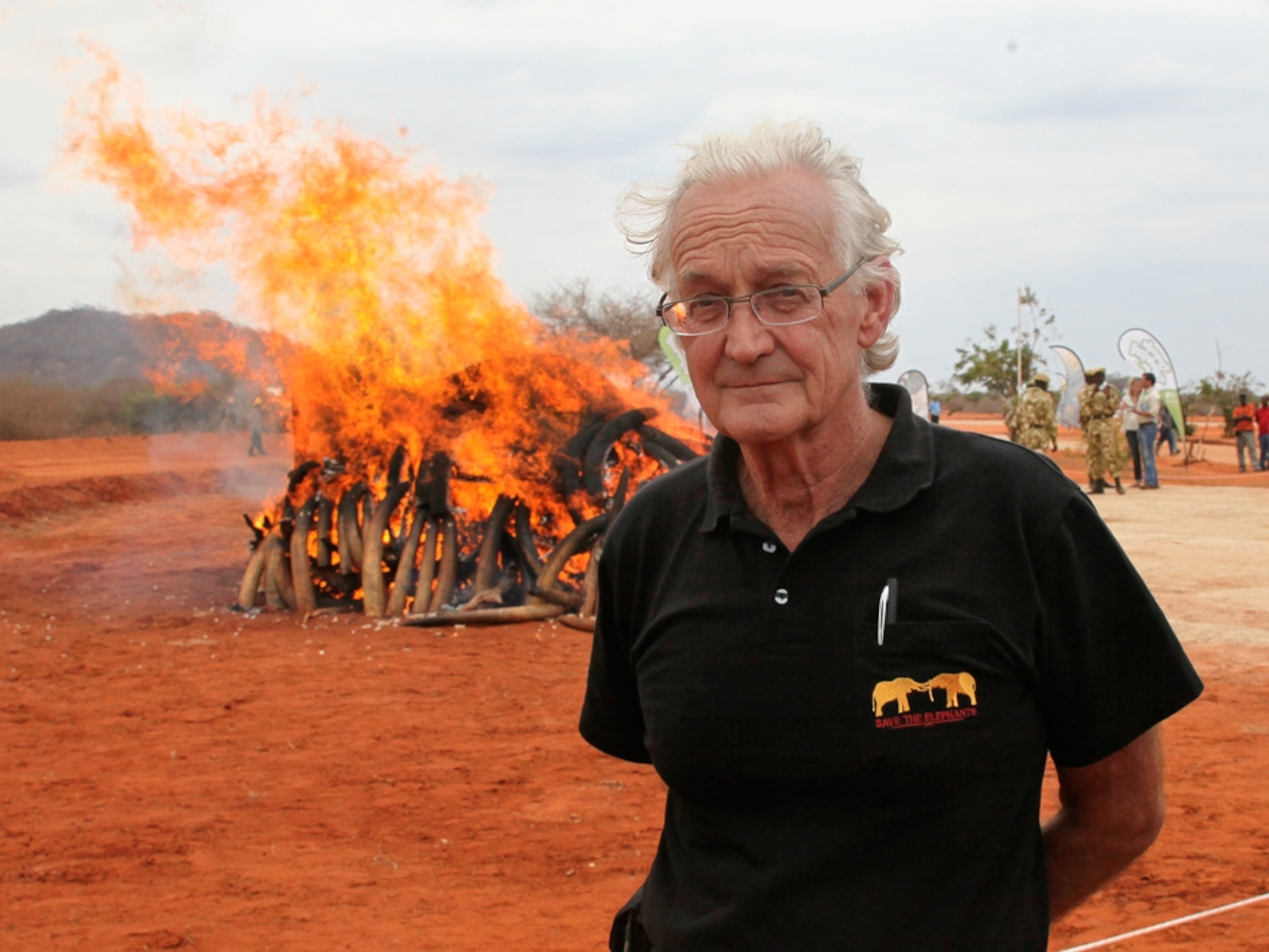 Iain Douglas-Hamilton near a pile of burning ivory in Kenya's Samburu National Reserve