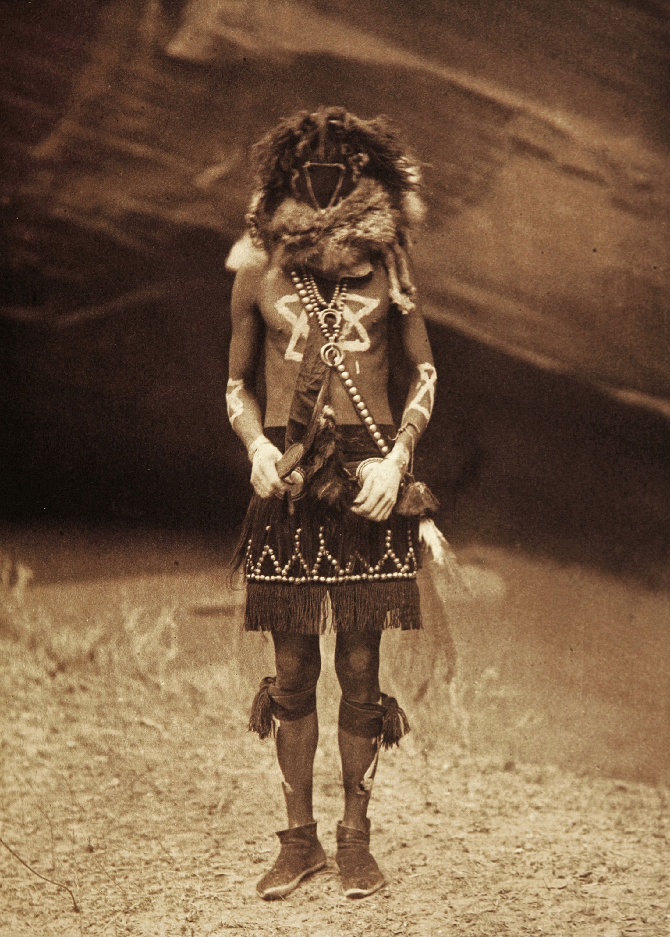 Native American man in ceremonial clothing.