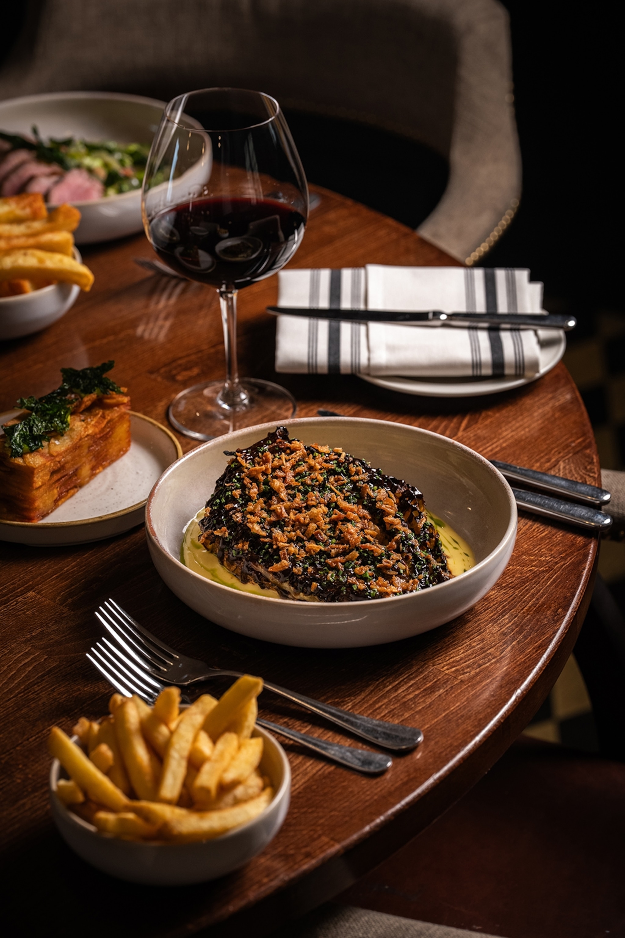 A wide bowl of food in a chic restaurant.