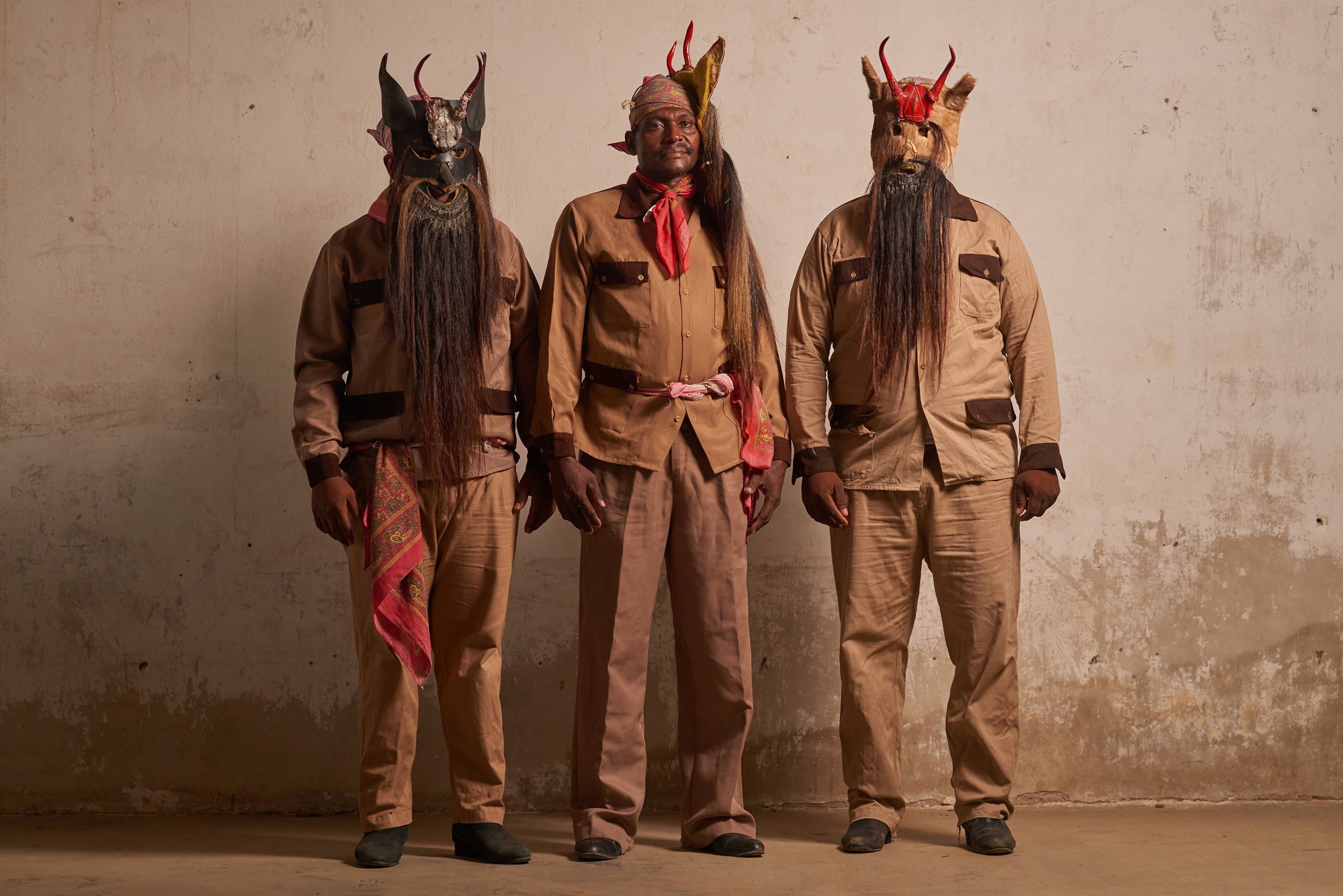 three Afromexican men from the town of Collantes wearing devil masks in Oaxaca, Mexico