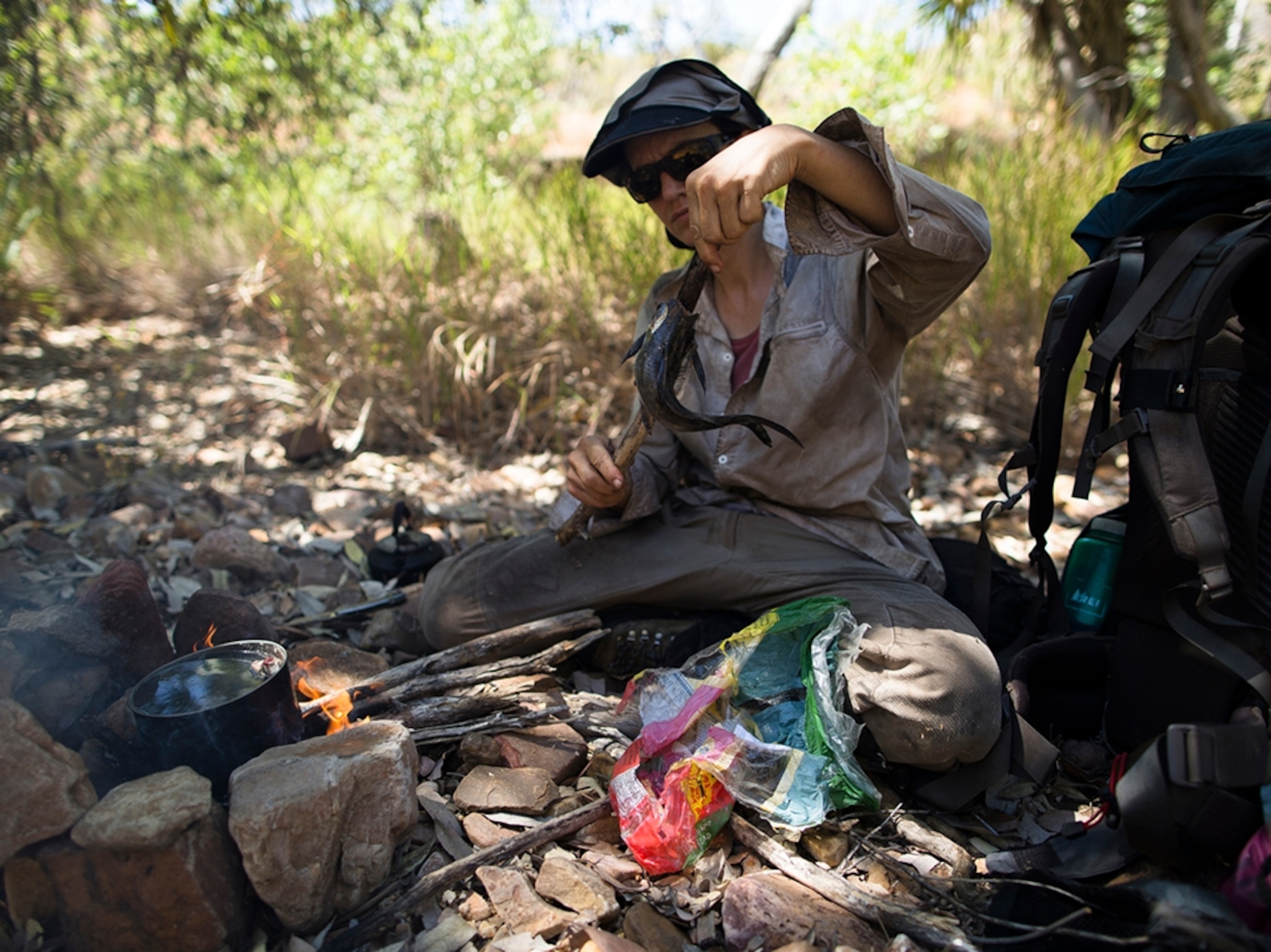 Sarah Marquis cooking a fish she caught.