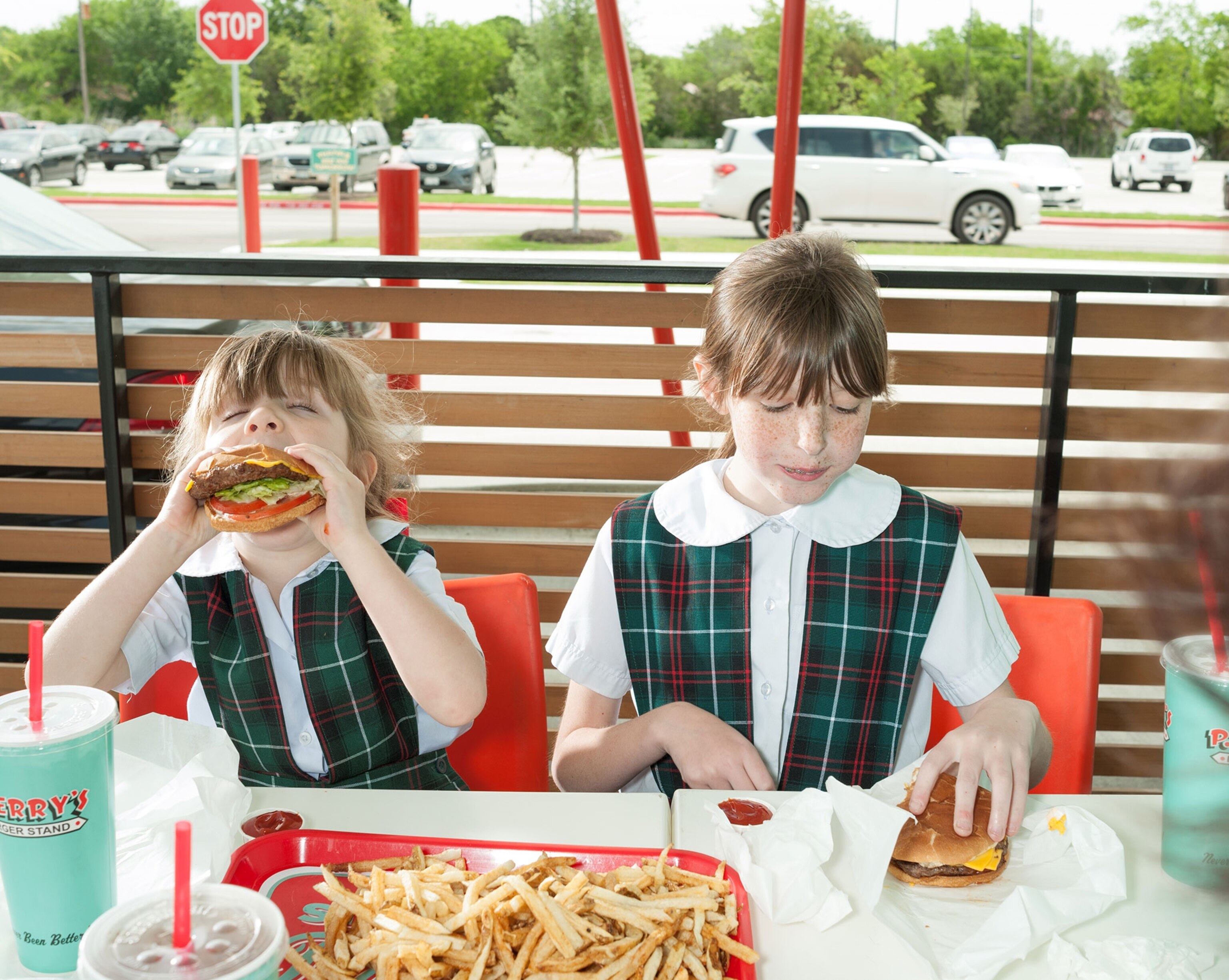 sisters eat hamburgers at a stand in Austin