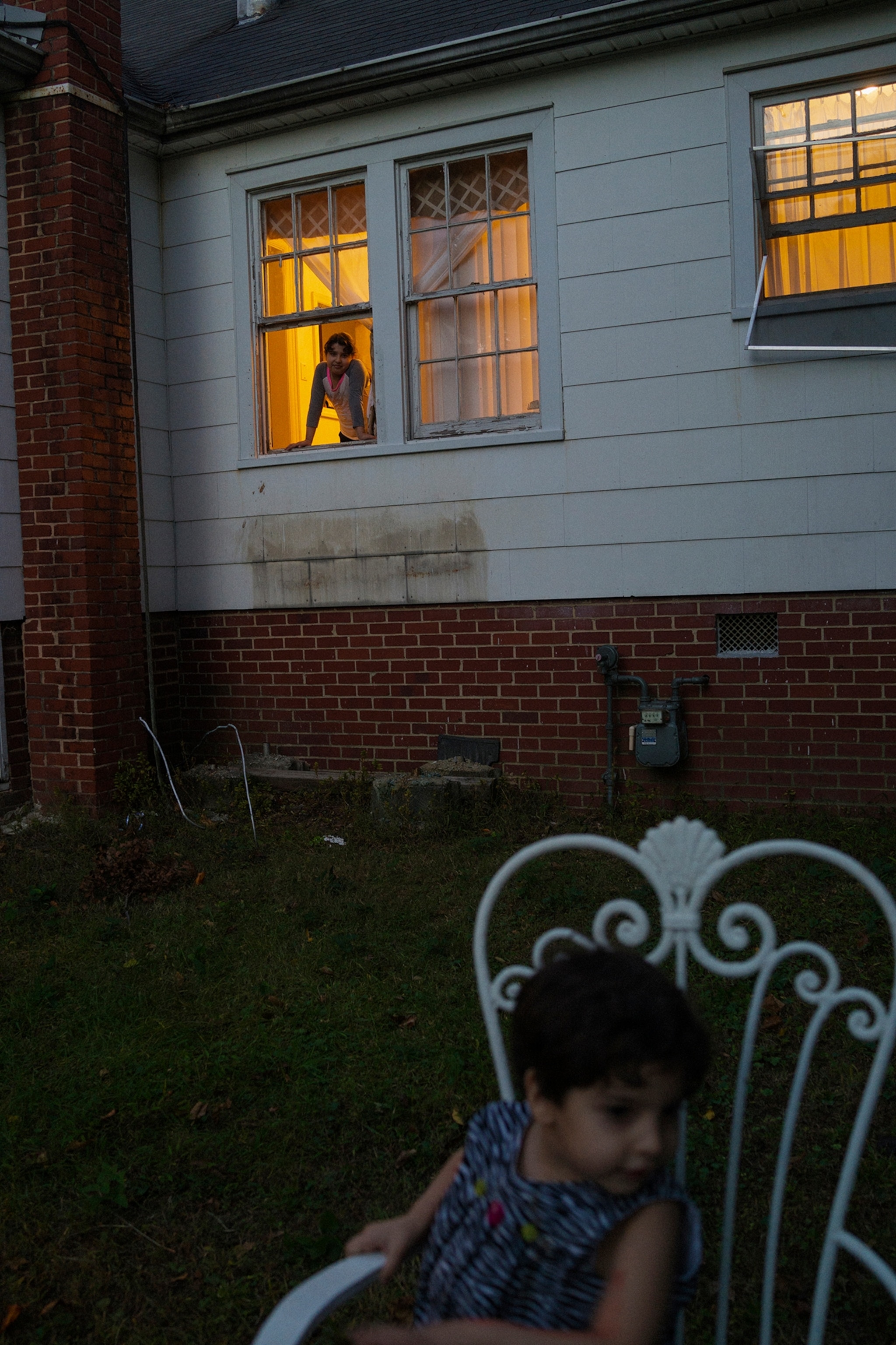 a child sitting in a chair outside a Greensboro, North Carolina home