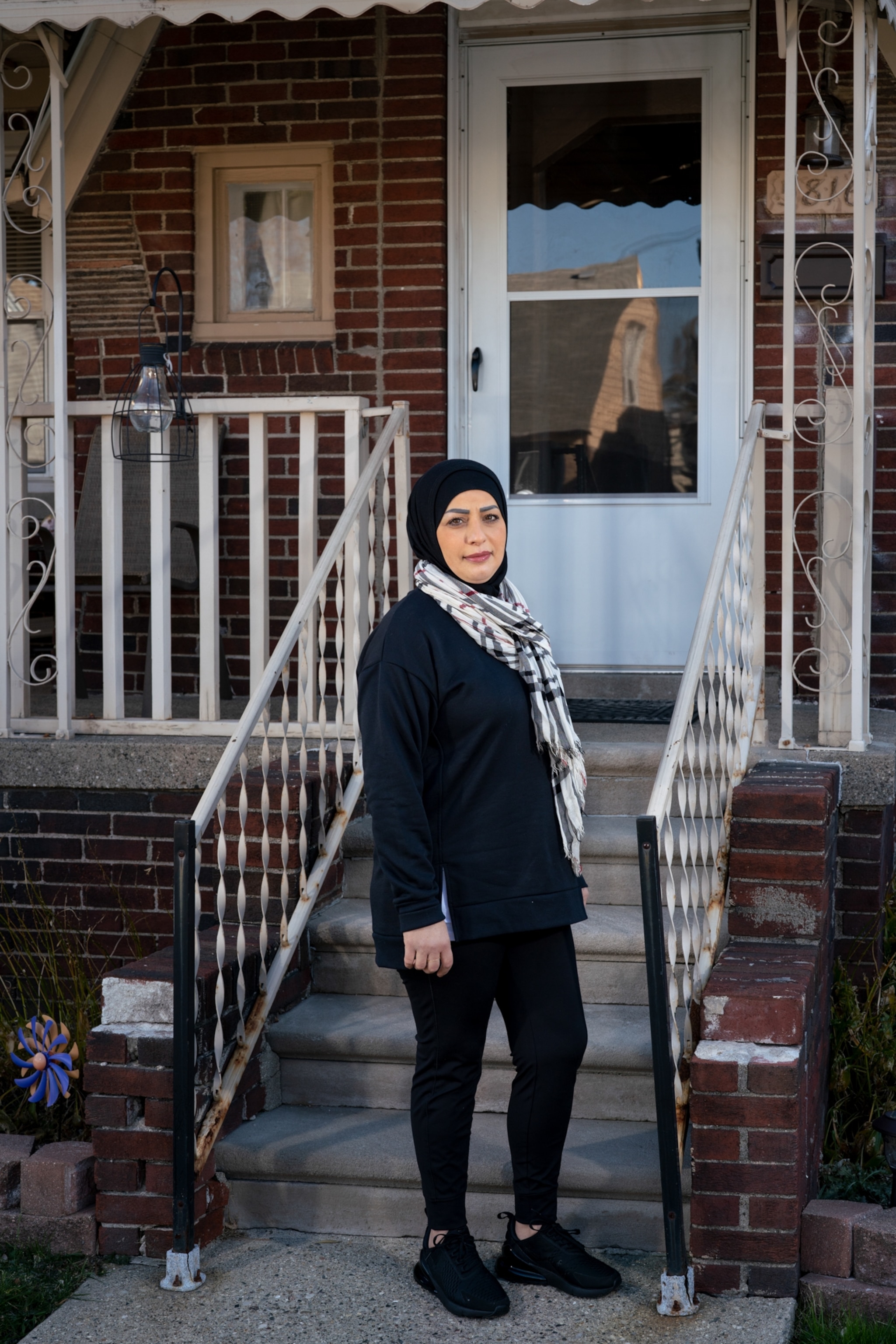 a picture of a woman standing on her front porch