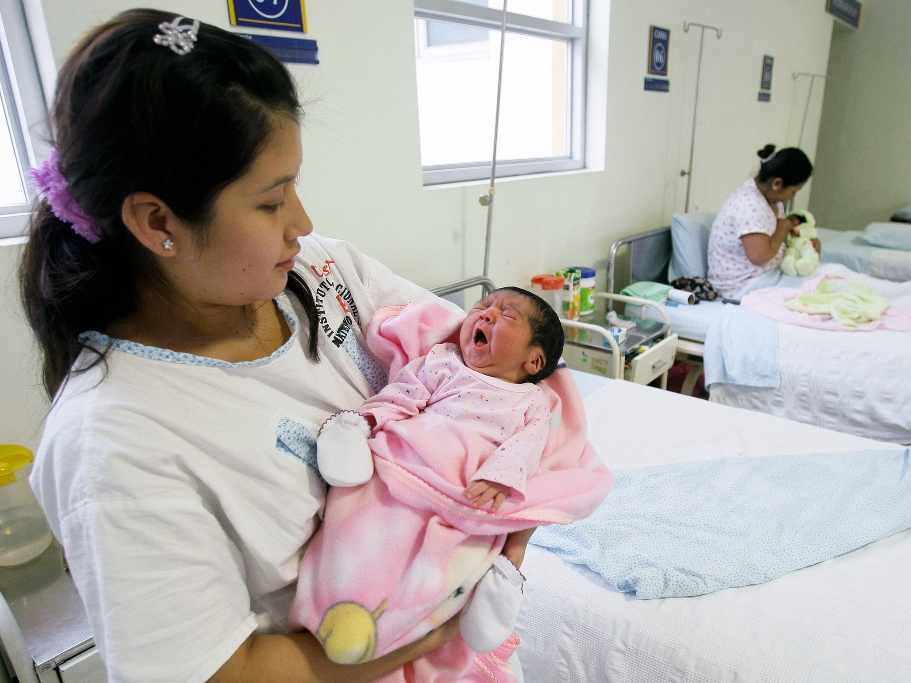 A mother holds her newborn daughter in a hospital in Lima, Peru.