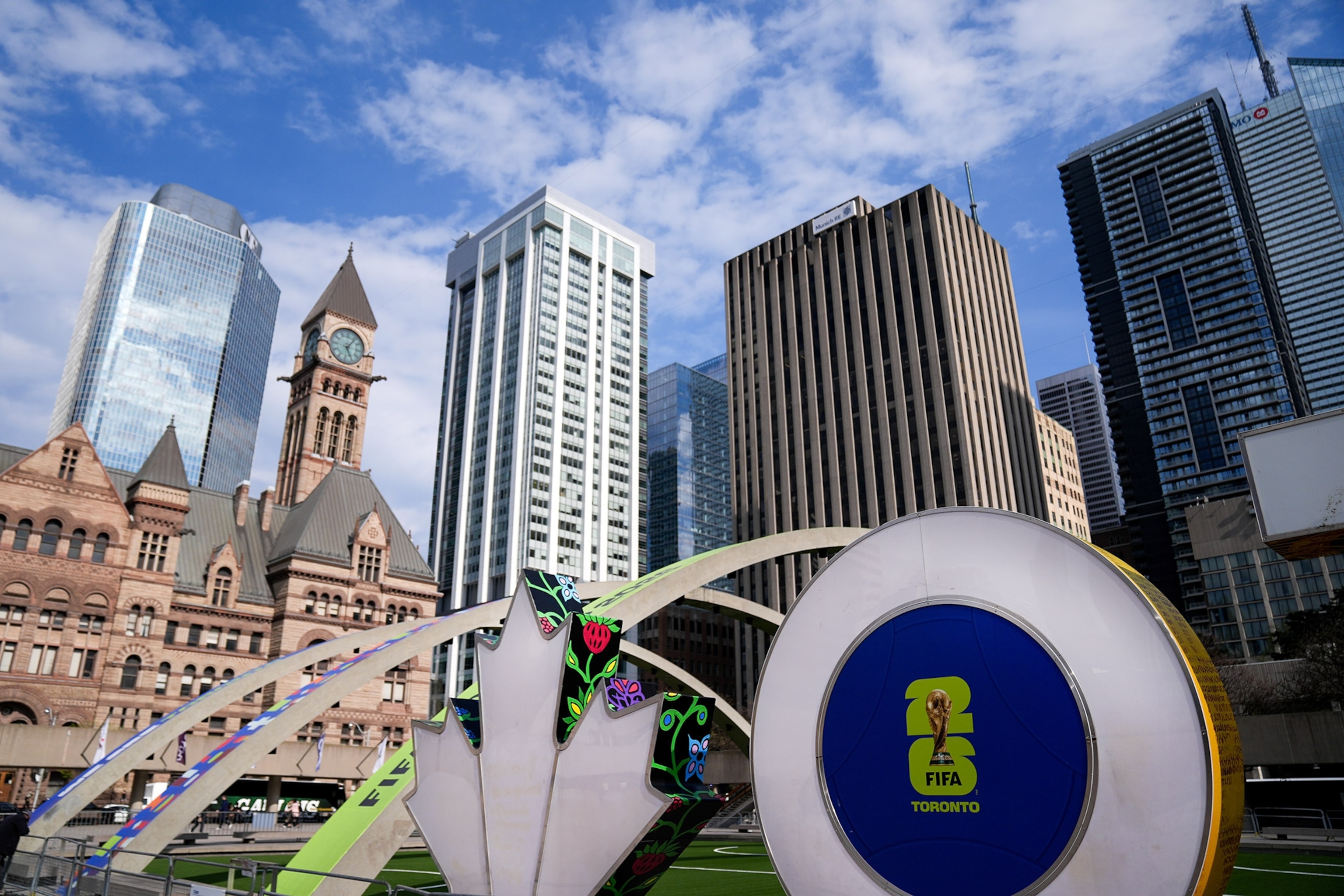 Canada Maple Leaf and O signs with FIFA insignia in the foreground, skyscrapers behind