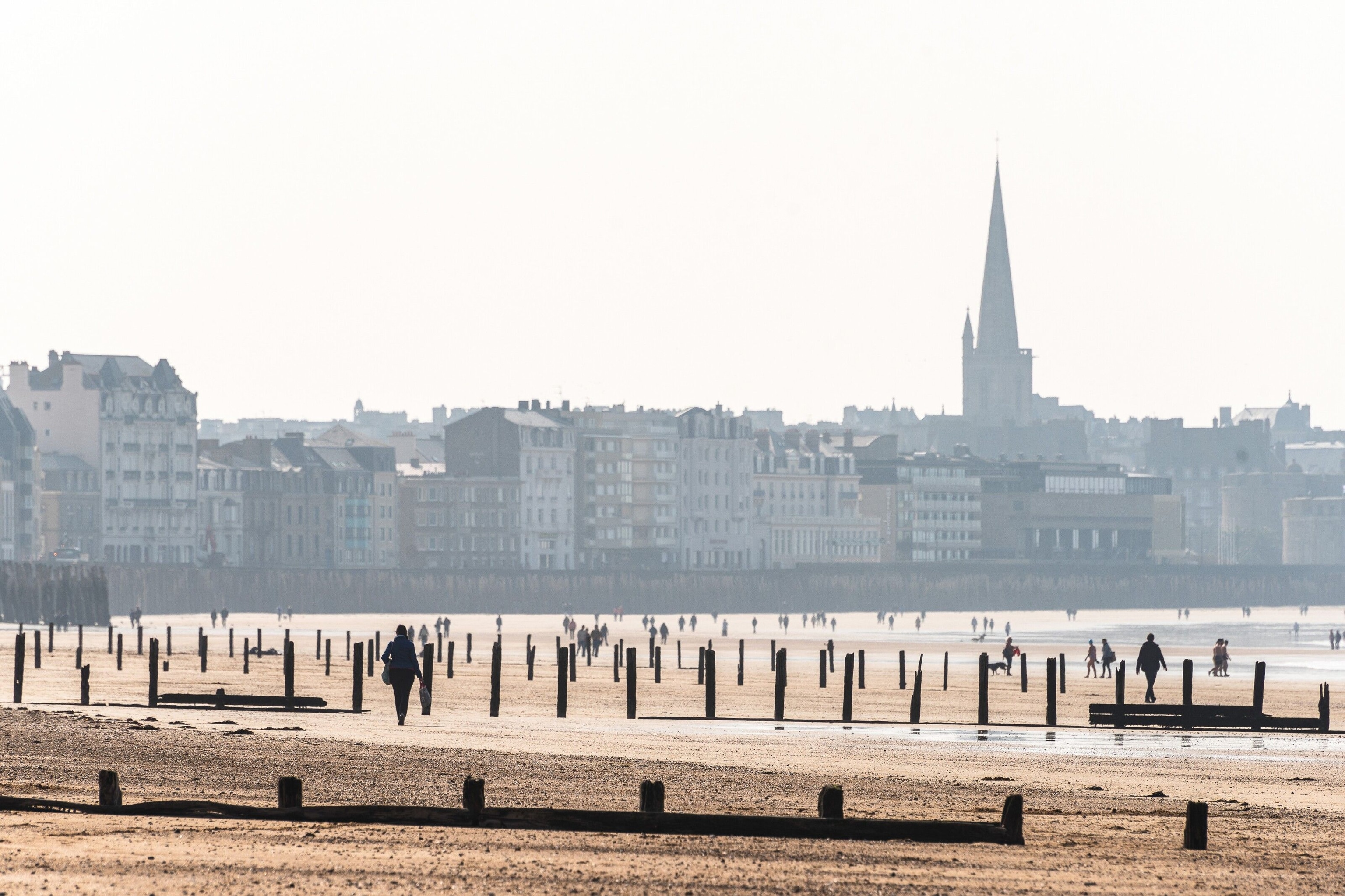Grande Plage du Sillon beach, in Saint-Malo, with the spire of the city’s cathedral in the distance.