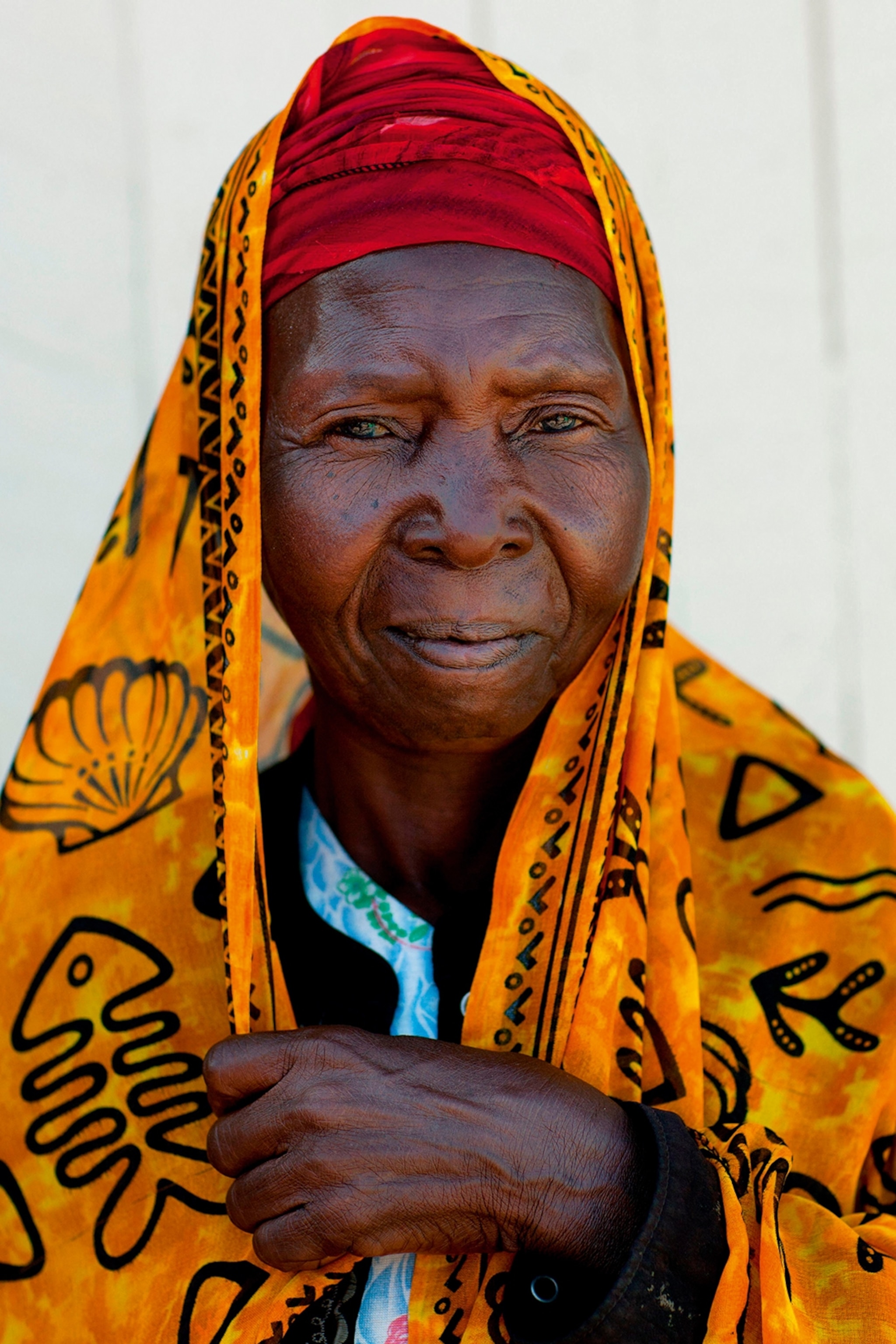 A local woman posing for a portrait, wearing a colourful hijab.