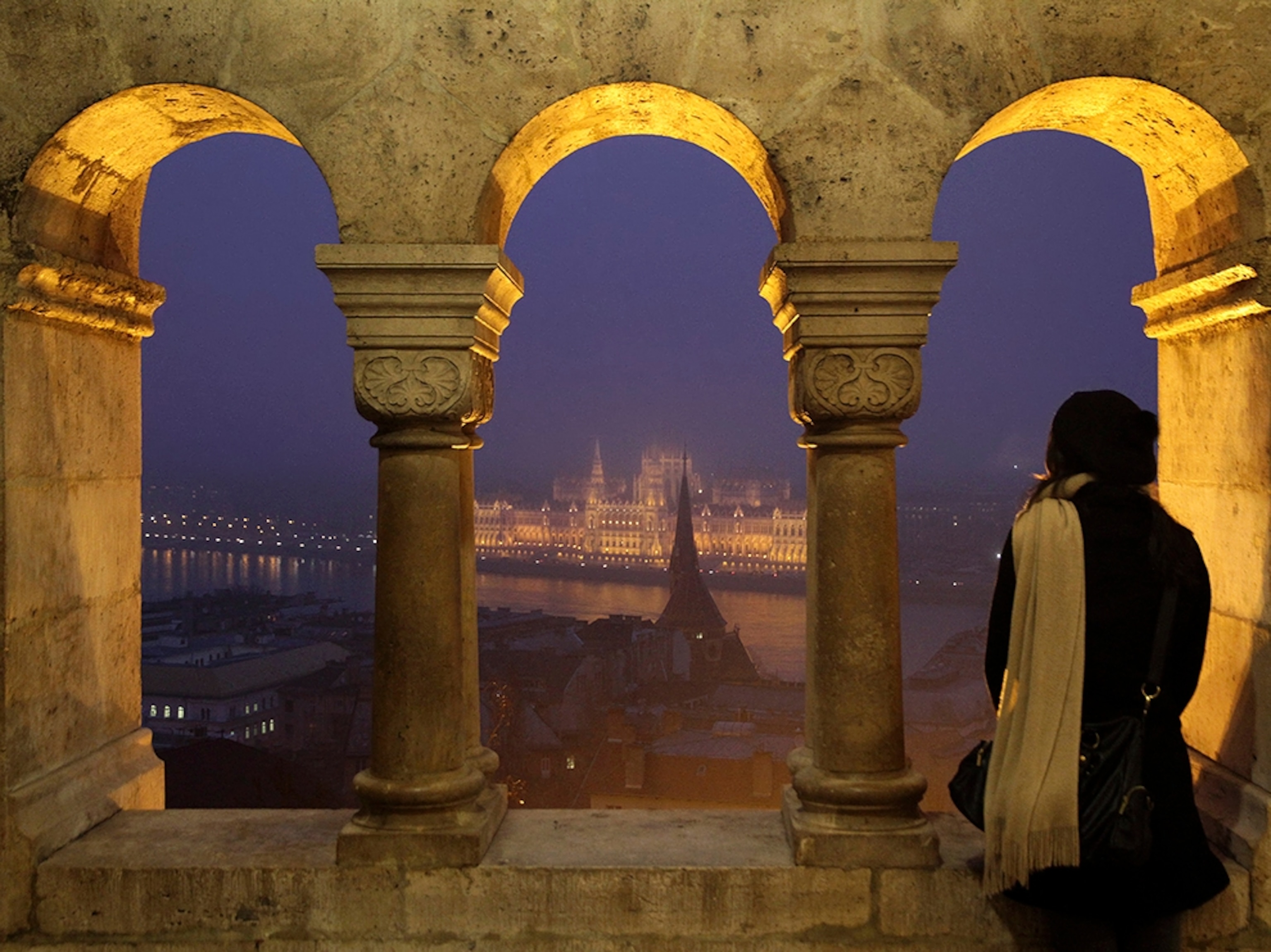 woman looking out at Parliament from Buda Castle, Budapest