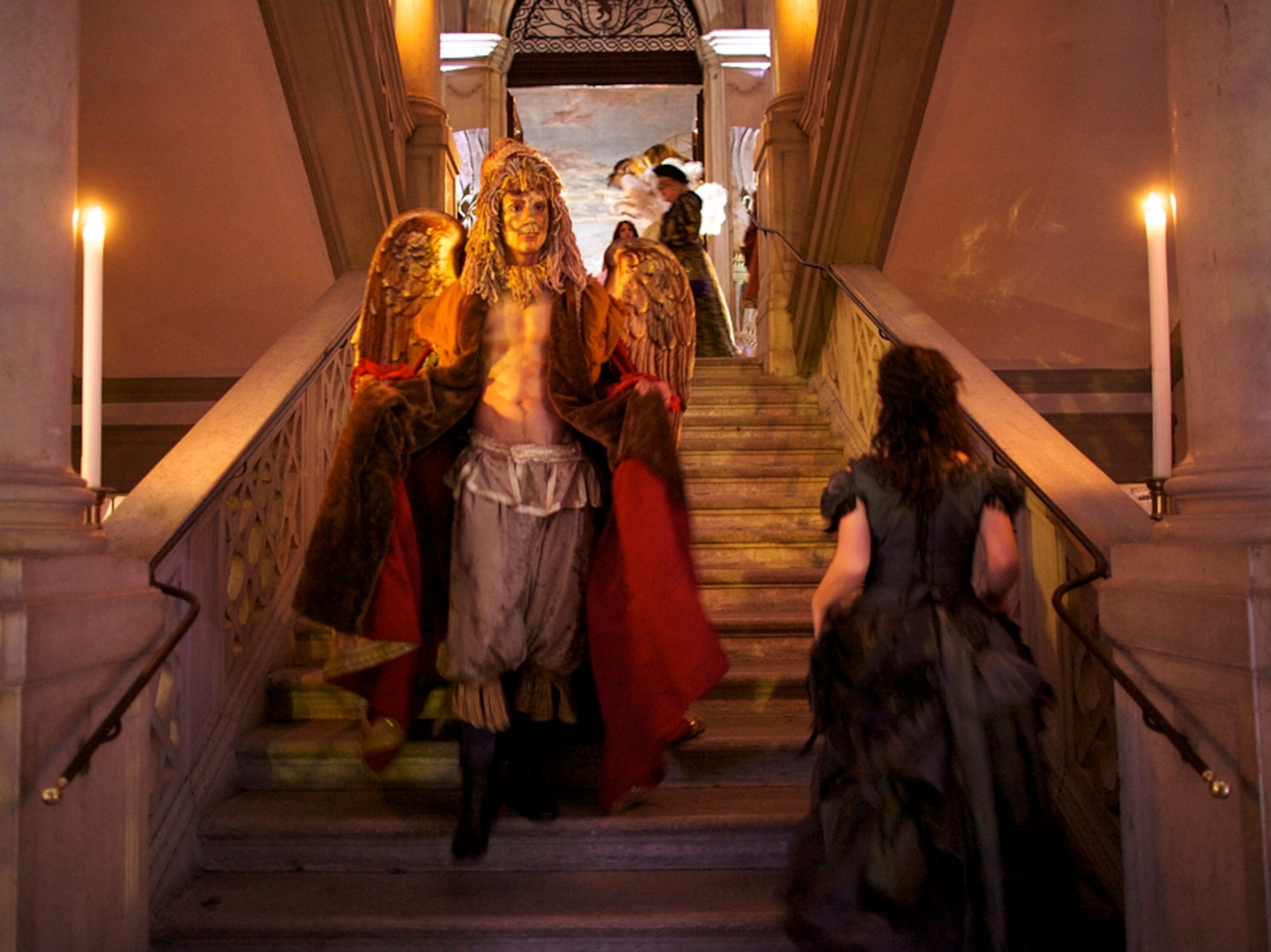 Man in angel costume on staircase
