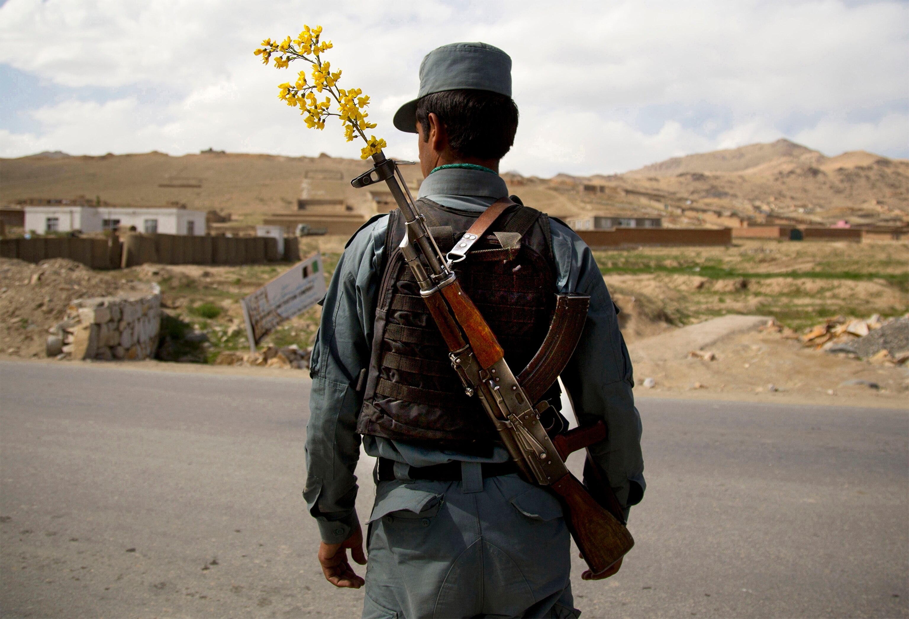an Afghan National Police officer manning a checkpoint.
