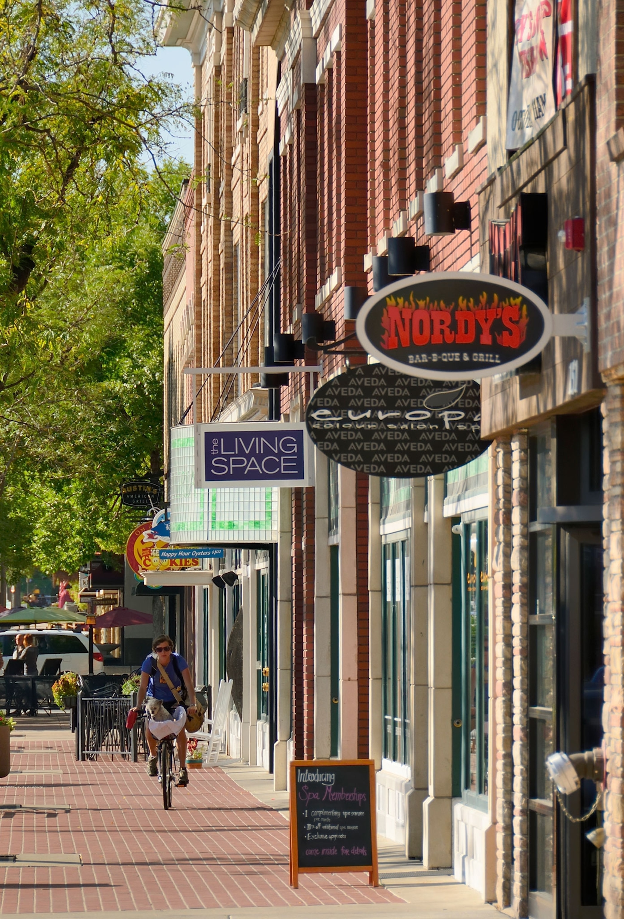 A beautiful day on South College Avenue, the main street of Fort Collins, Colorado with people and cyclist in the background