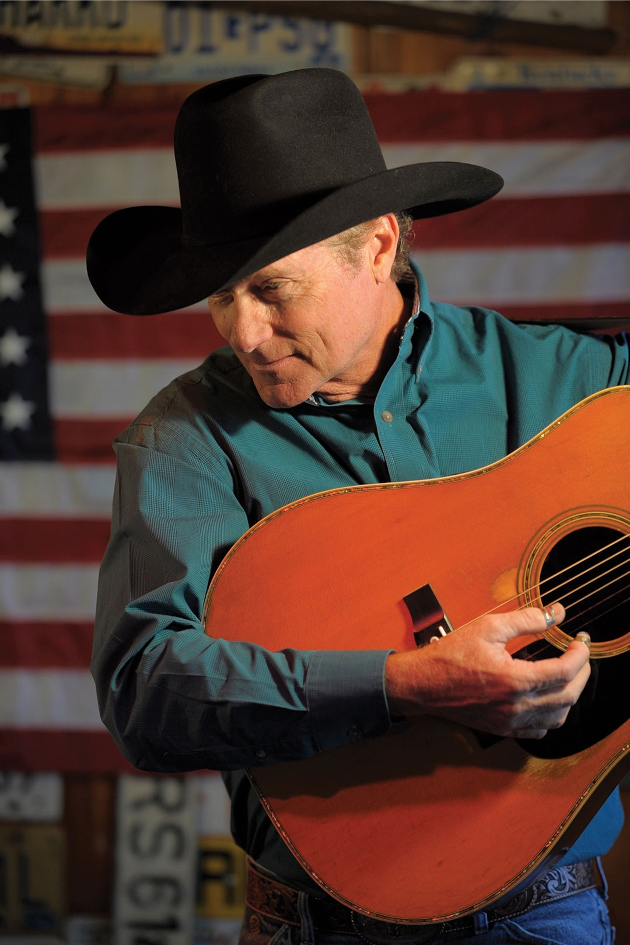 Man in cowboy hat playing guitar