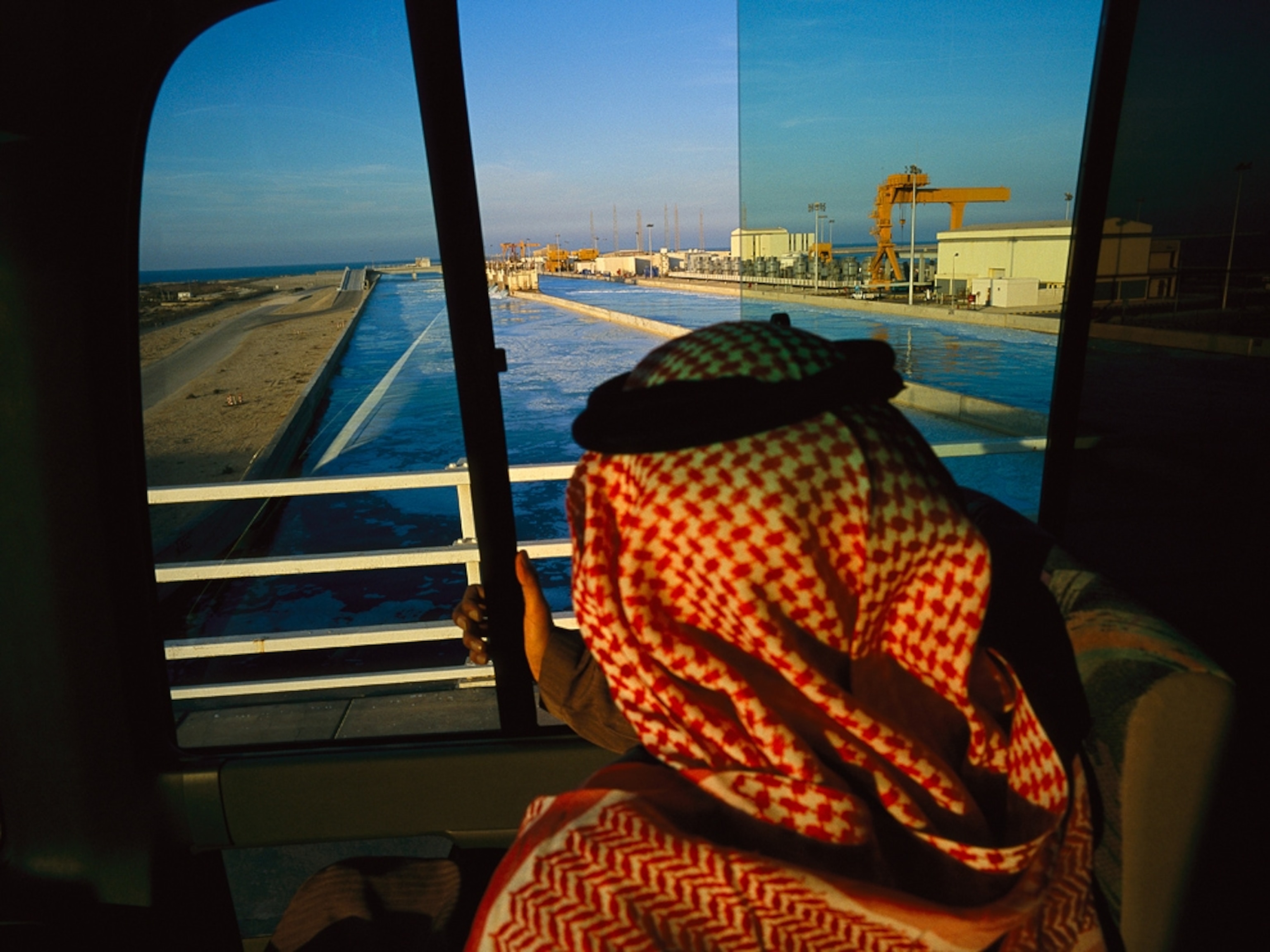 A man views the industrial city of Jubail, Saudi Arabia