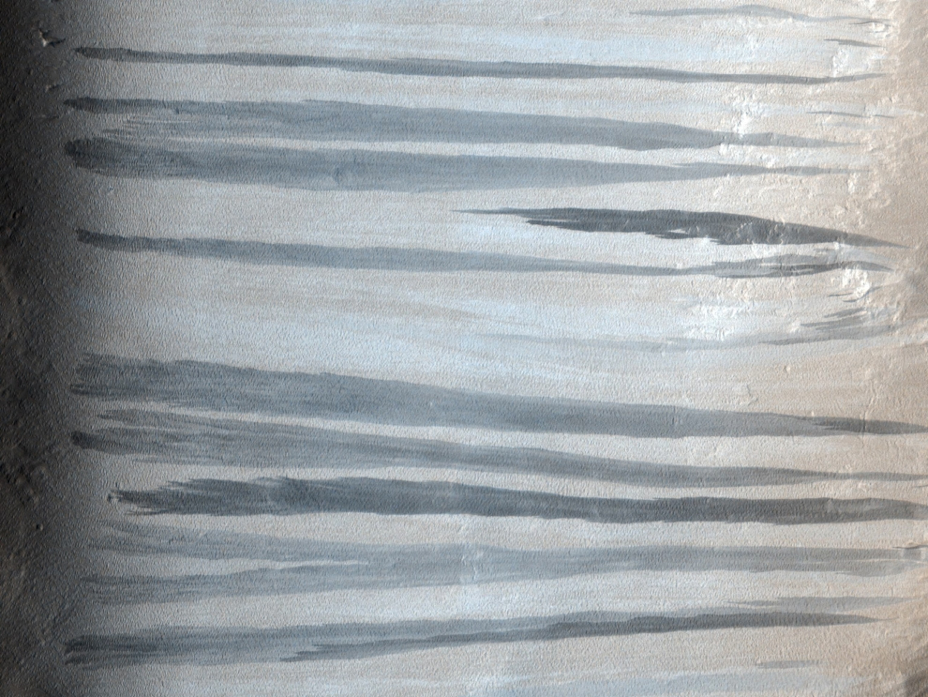 A new picture shows recently made streaks along the slopes of a Martian crater wall.