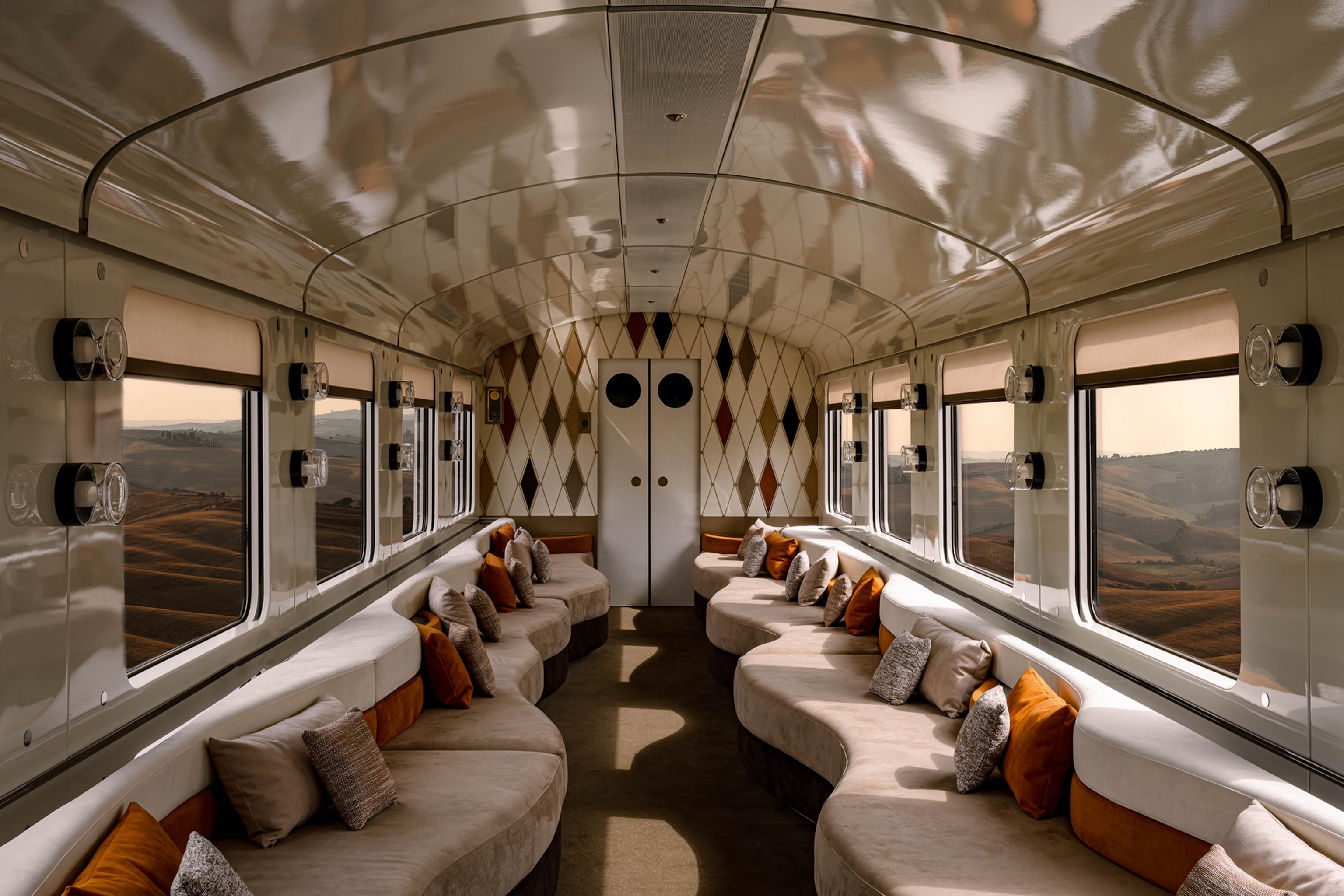 The interiors of a luxurious train carriage with sofas on either side and small table lamps.