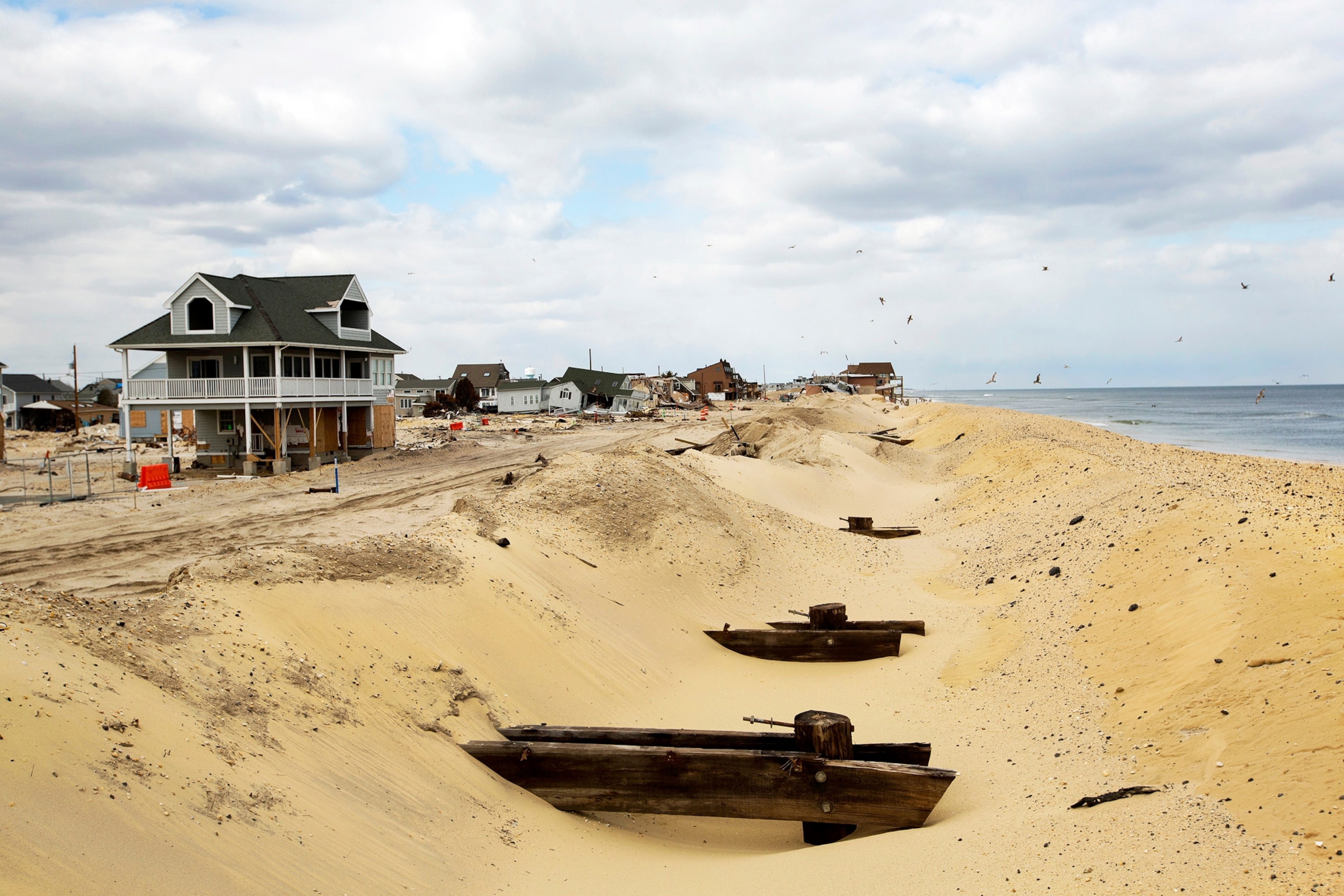 Temporary dunes to protect homes bury the remains of a boardwalk nearly five months after the landfall of Superstorm Sandy in Ortley Beach, New Jersey, March 22, 2013.