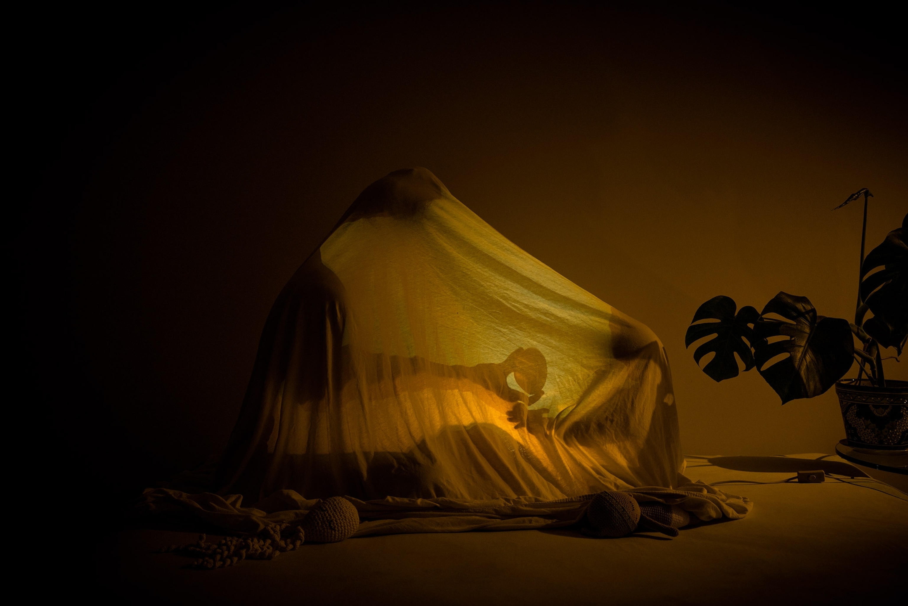 a mother and son in a blanket fort