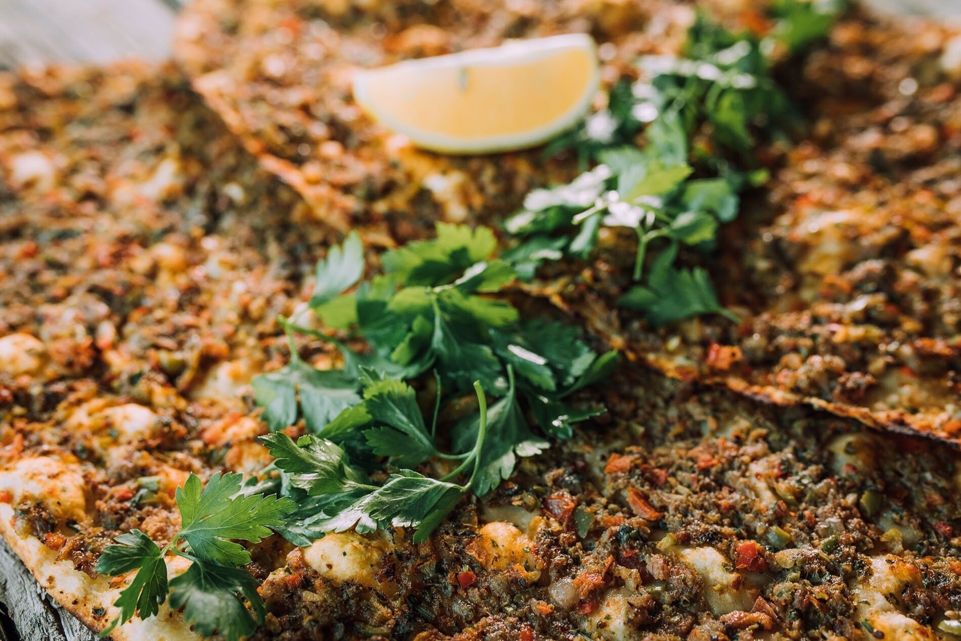 Lahmacun — Turkey’s answer to pizza — is a crispy, round flatbread topped with a thin layer of minced beef, herbs and vegetables