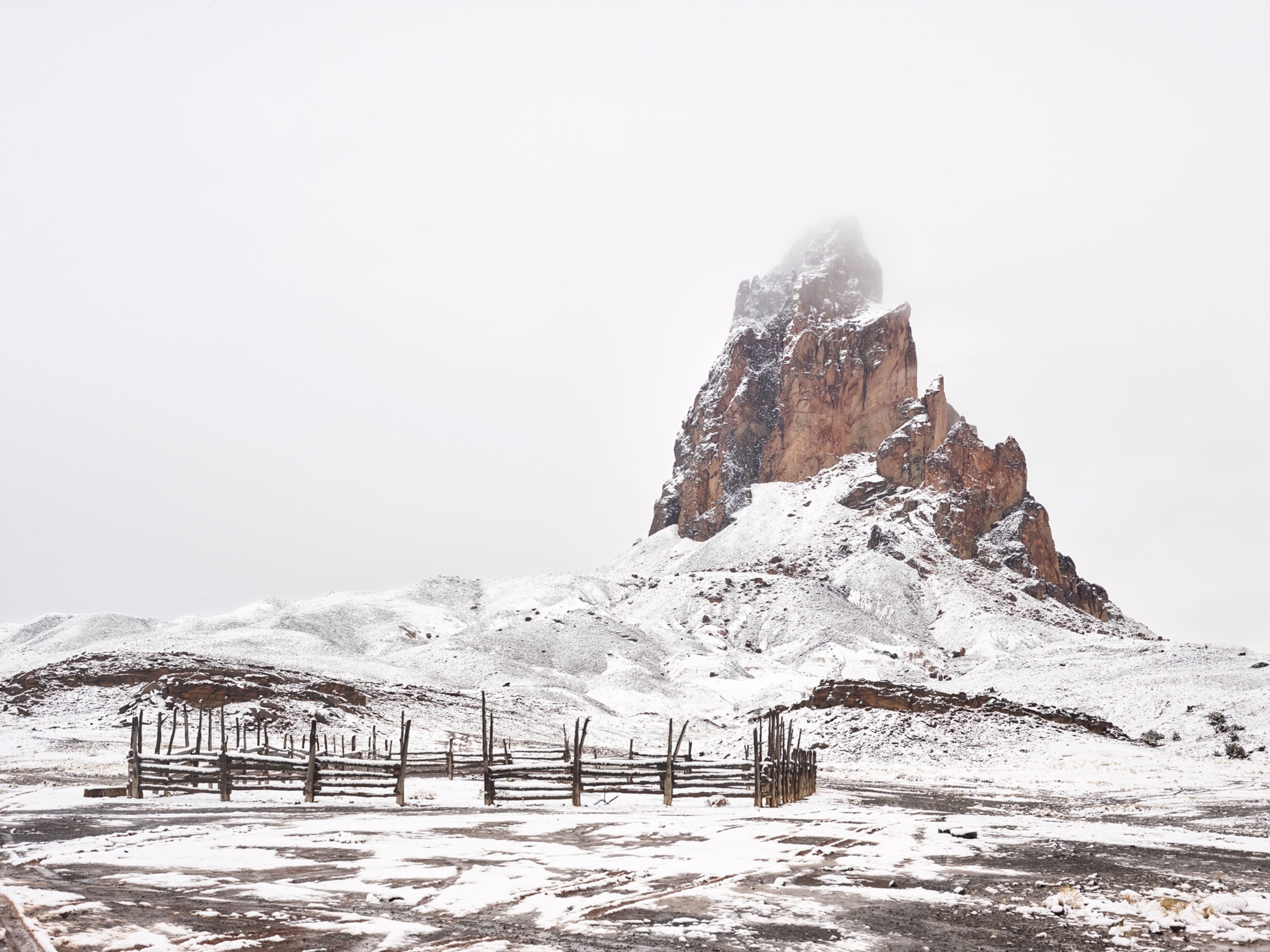 a snowcapped Agathla Peak in Arizona