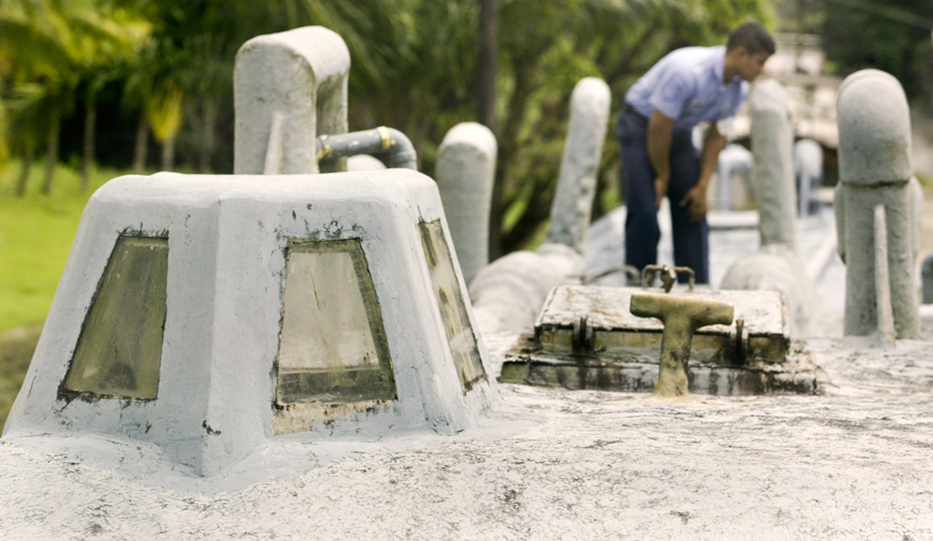 a sailor walking the deck of a semi-submersible, fiberglass cocaine submarine