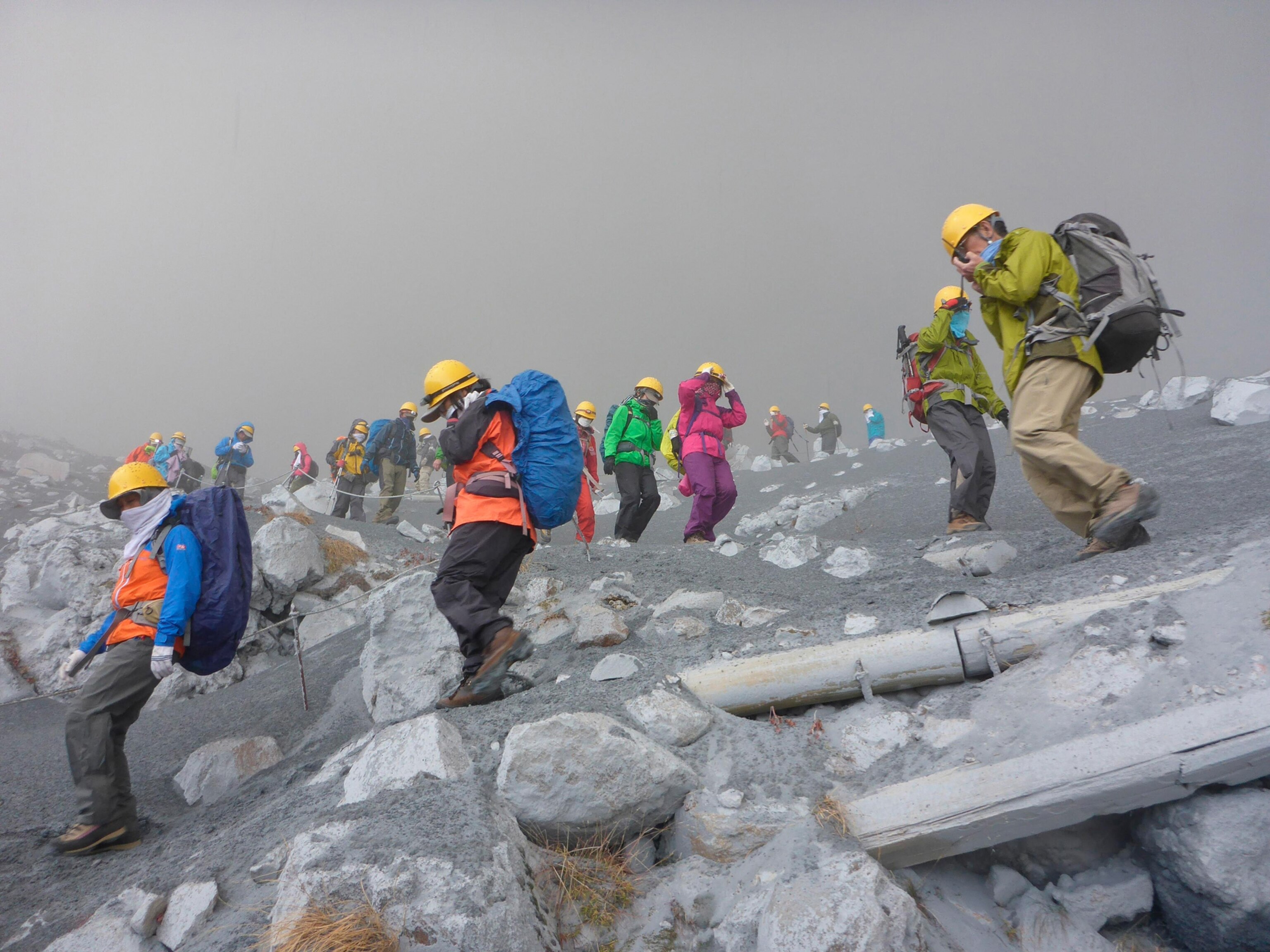Climbers descend Mt. Ontake, which straddles Nagano and Gifu prefectures, to evacuate as volcanic ash falls at the mountain in central Japan September 27, 2014, in this photo taken by a climber and released by Kyodo. The Mt. Ontake volcano erupted on Saturday, killing one woman and seriously injuring more than 30 people, officials and media said. The Japan Meteorological Agency said the volcano, 200 km (125 miles) west of Tokyo, erupted just before midday and sent ash pouring down the mountain's south slope for more than three km (two miles). Mandatory credit. REUTERS/Kyodo (JAPAN - Tags: DISASTER ENVIRONMENT TPX IMAGES OF THE DAY) ATTENTION EDITORS - THIS IMAGE HAS BEEN SUPPLIED BY A THIRD PARTY. IT IS DISTRIBUTED, EXACTLY AS RECEIVED BY REUTERS, AS A SERVICE TO CLIENTS. MANDATORY CREDIT. JAPAN OUT. NO COMMERCIAL OR EDITORIAL SALES IN JAPAN - RTR47XPP