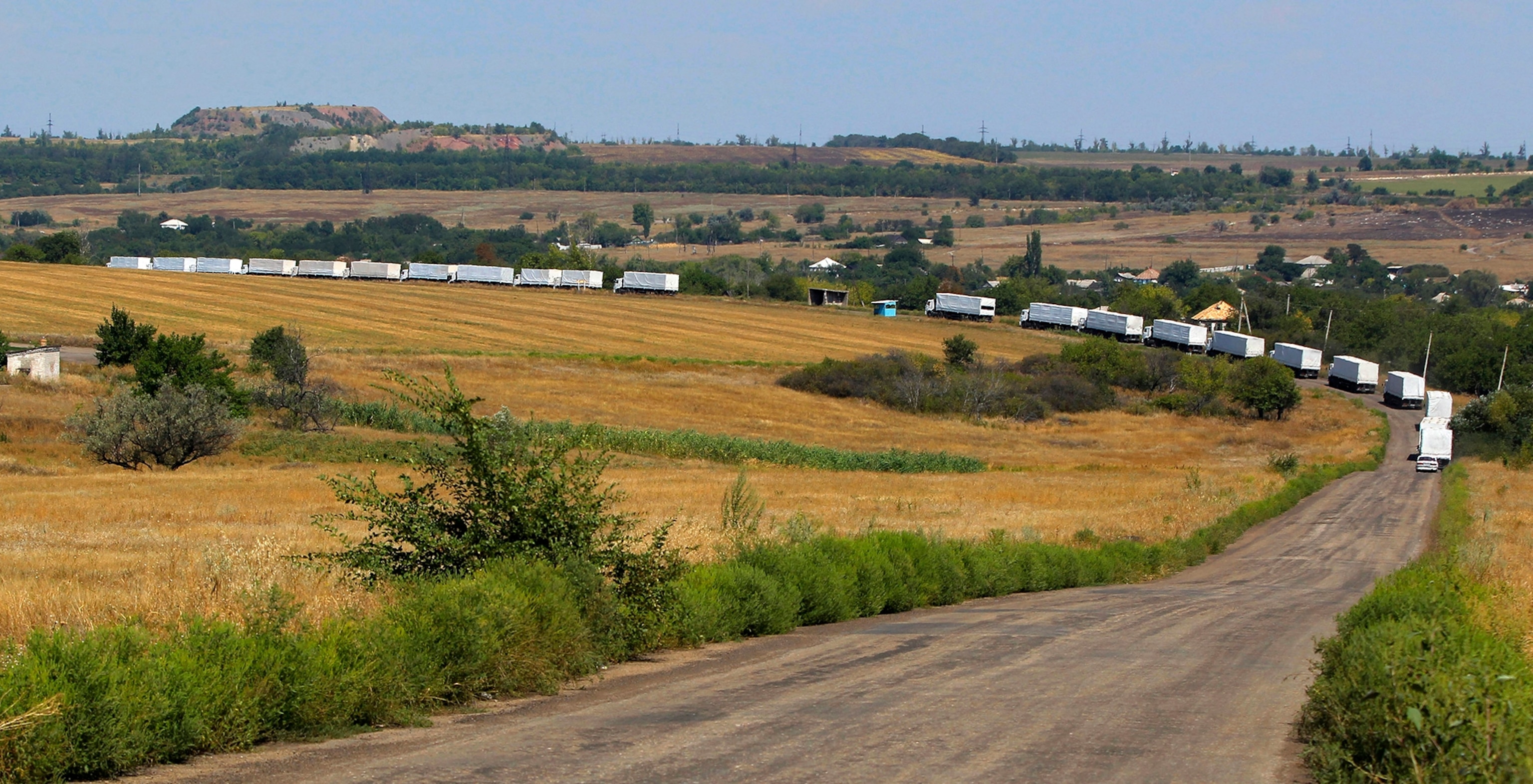 A Ukrainian soldier stands on a tank in a military camp, near the eastern Ukrainian town of Rassypnoe.