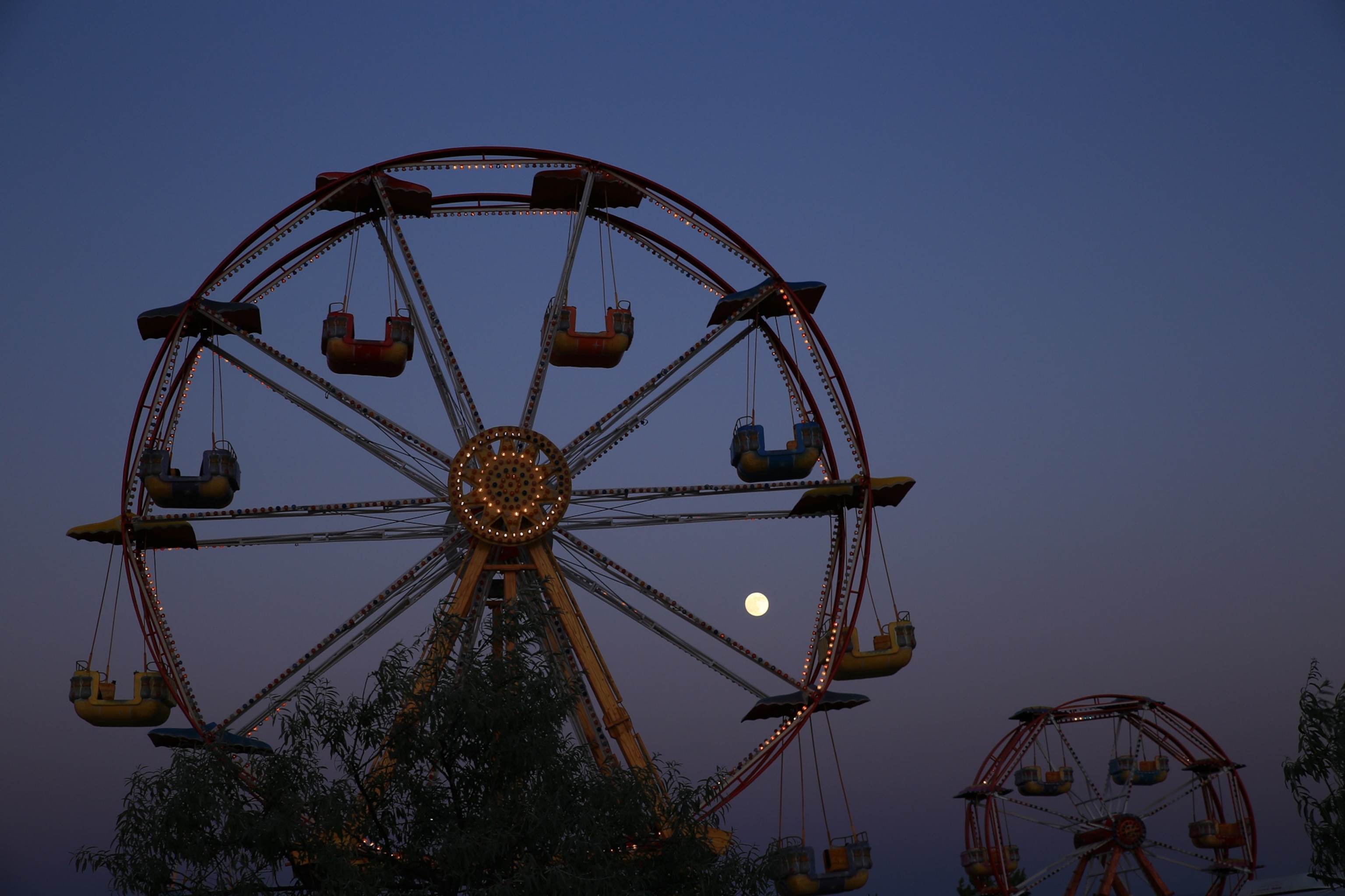 the supermoon behind a Ferris wheel in Turkey