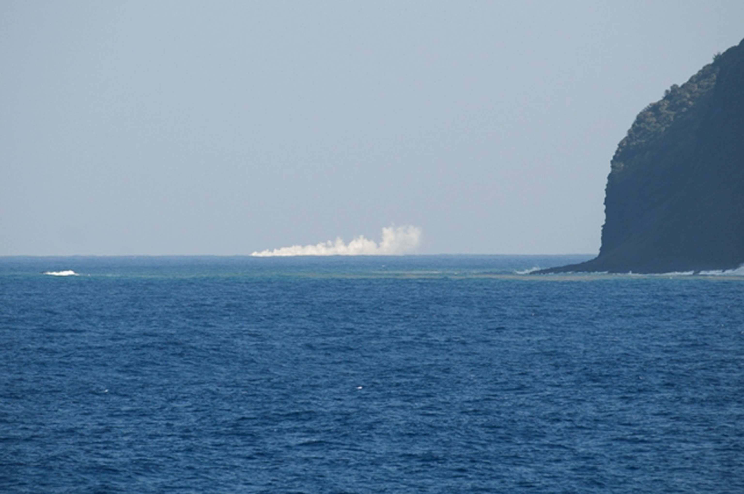 Picture of ash and smoke rising from undersea volcano eruption off Japan