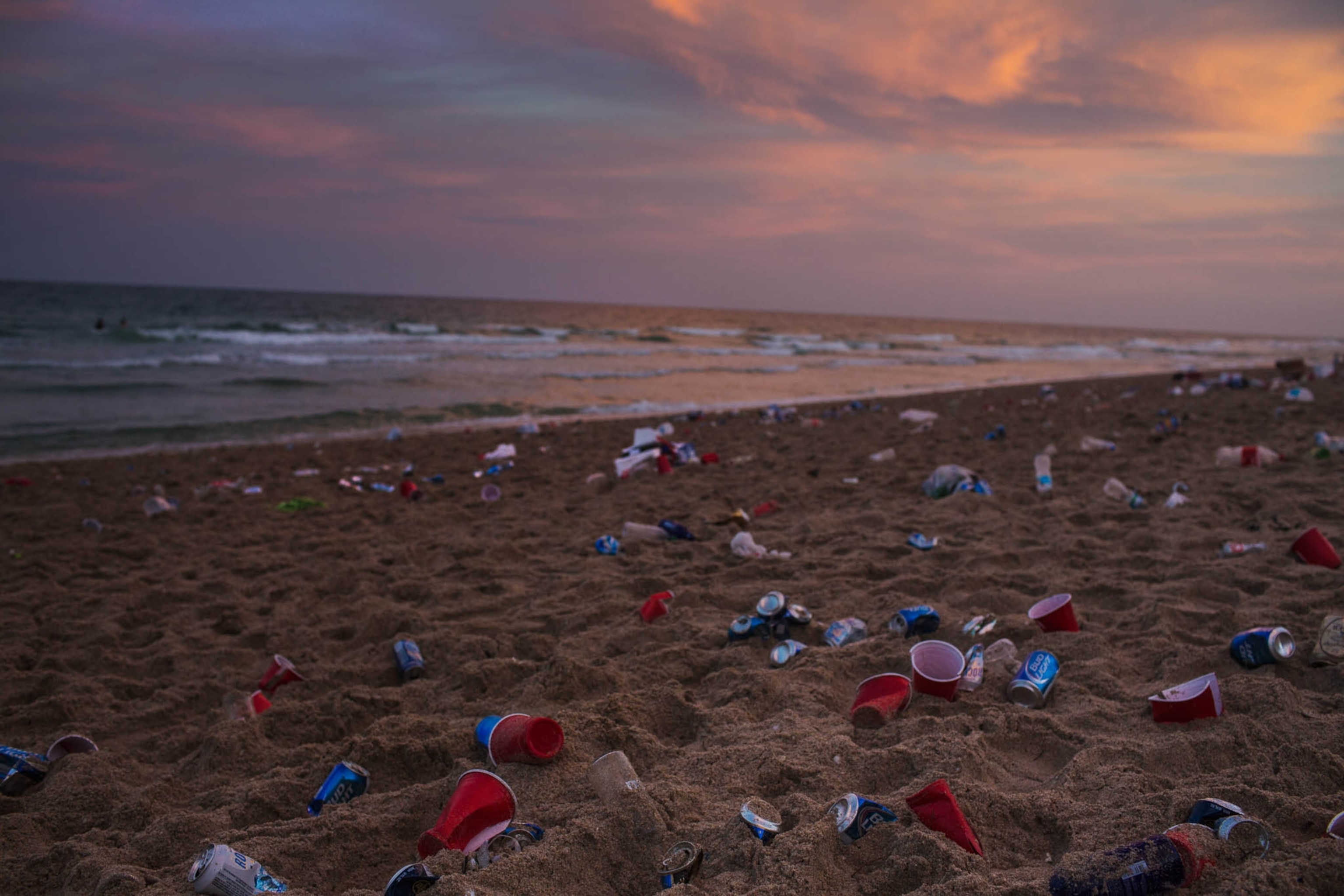 trash strewn across the beach in Fort Lauderdale, Florida