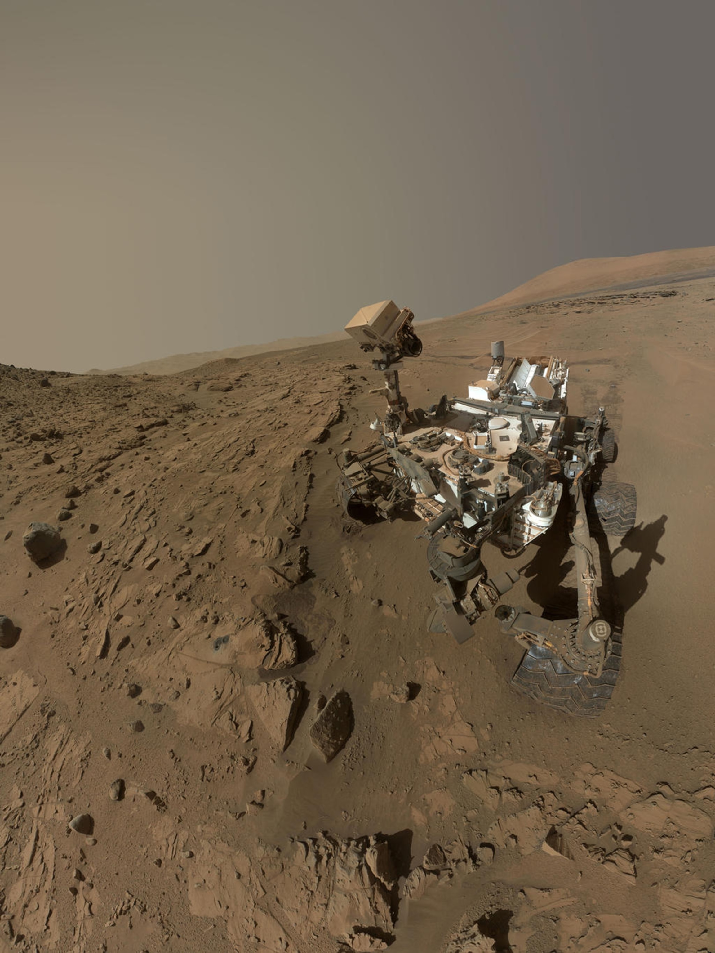 NASA's Curiosity Mars rover used the camera at the end of its arm in April and May 2014 to take dozens of component images combined into this self-portrait where the rover drilled into a sandstone target called "Windjana."