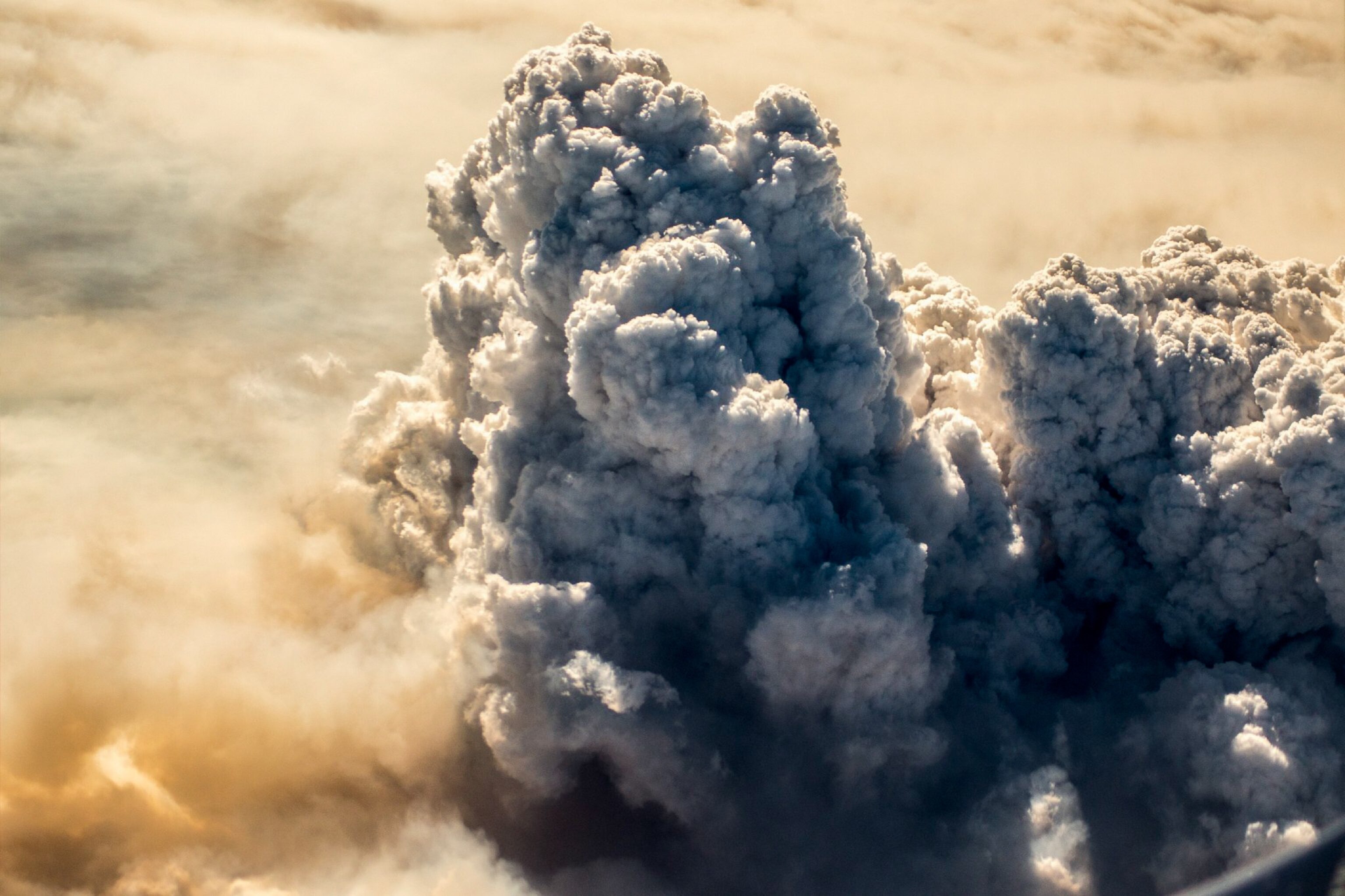 Aerial photo of a billowing smoke cloud above a fire in the Northwest Territories, Canada.