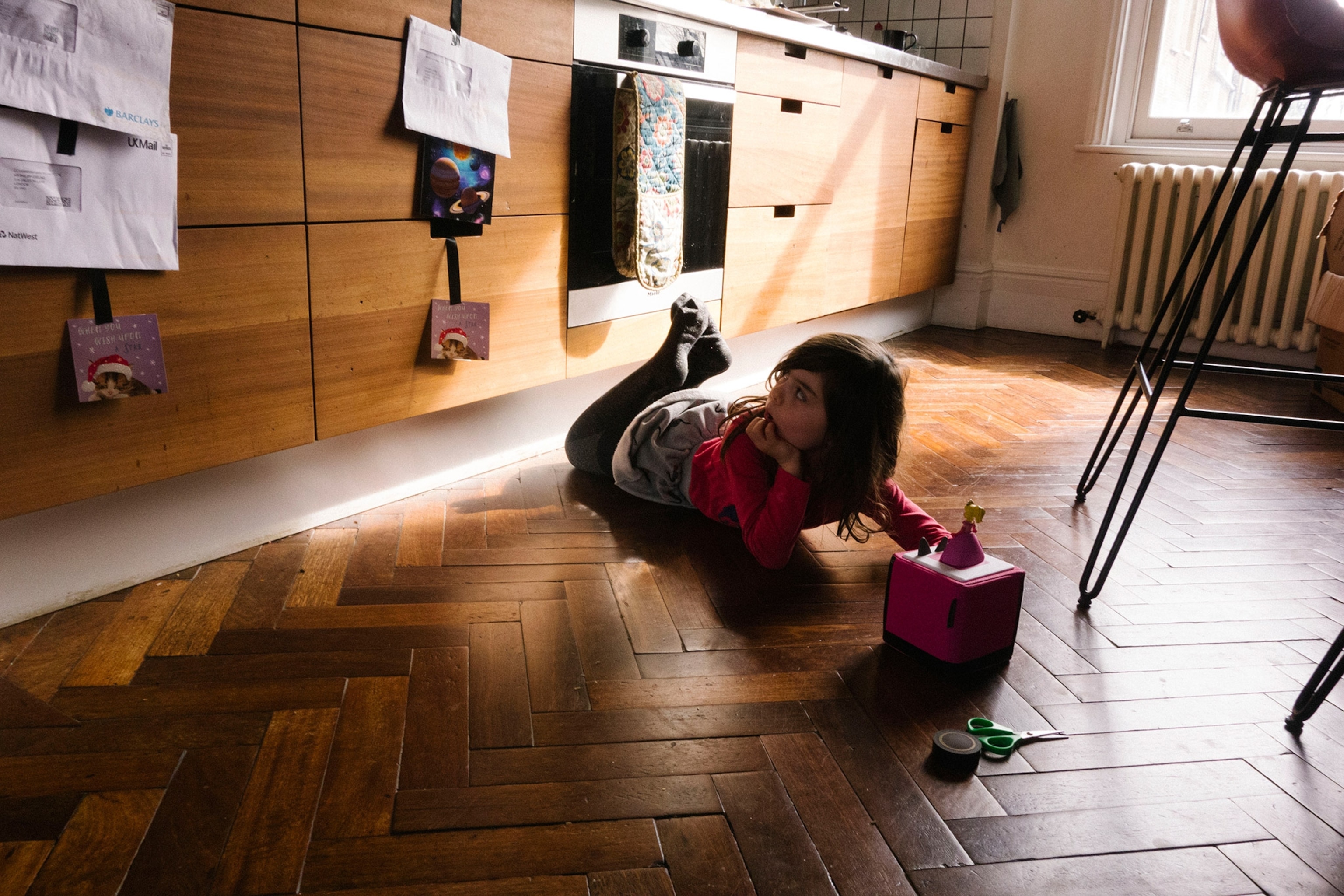 a little girl on a kitchen floor
