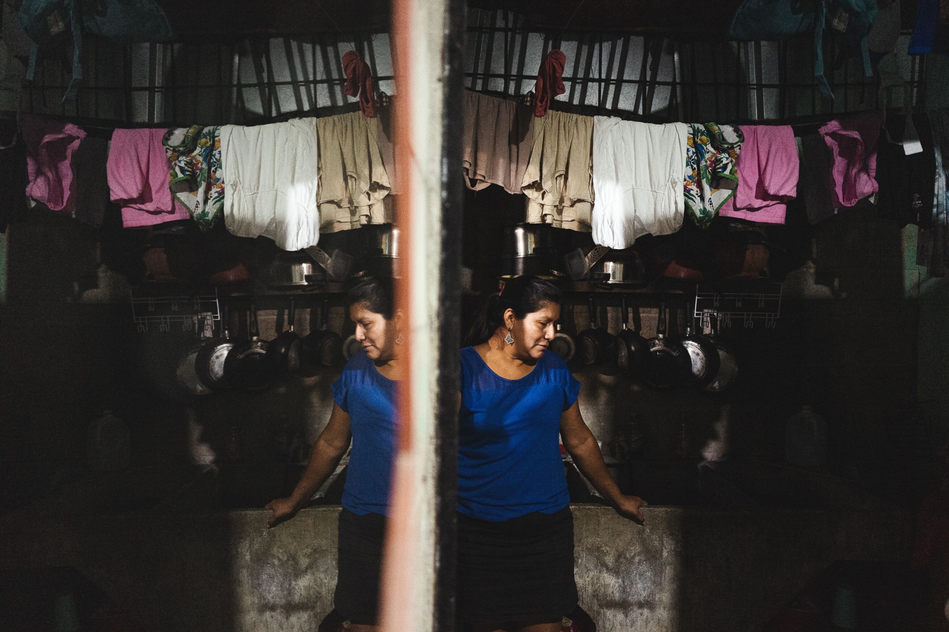 A woman poses for a portrait in her home in El Salvador