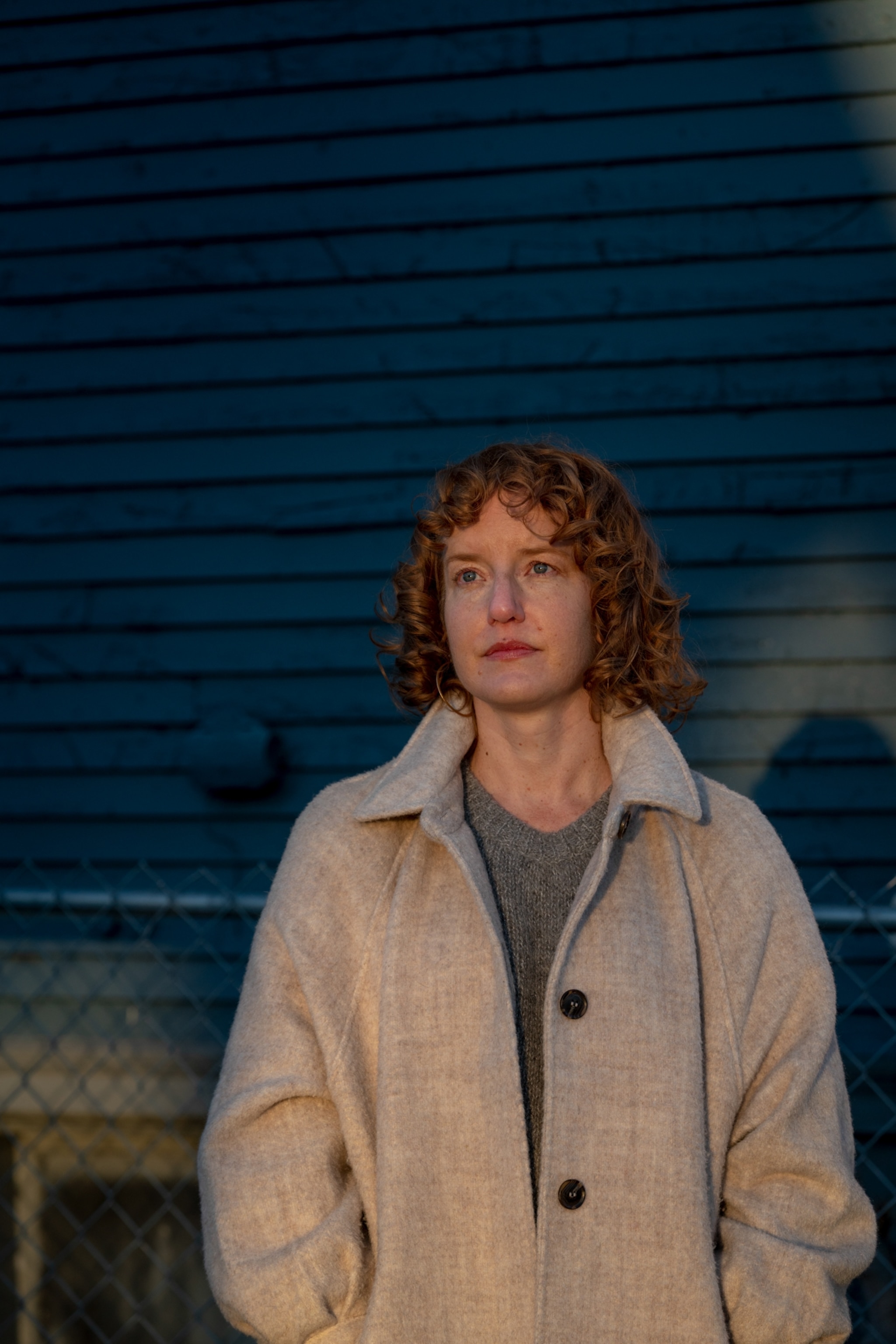 a woman stands outside in the snow