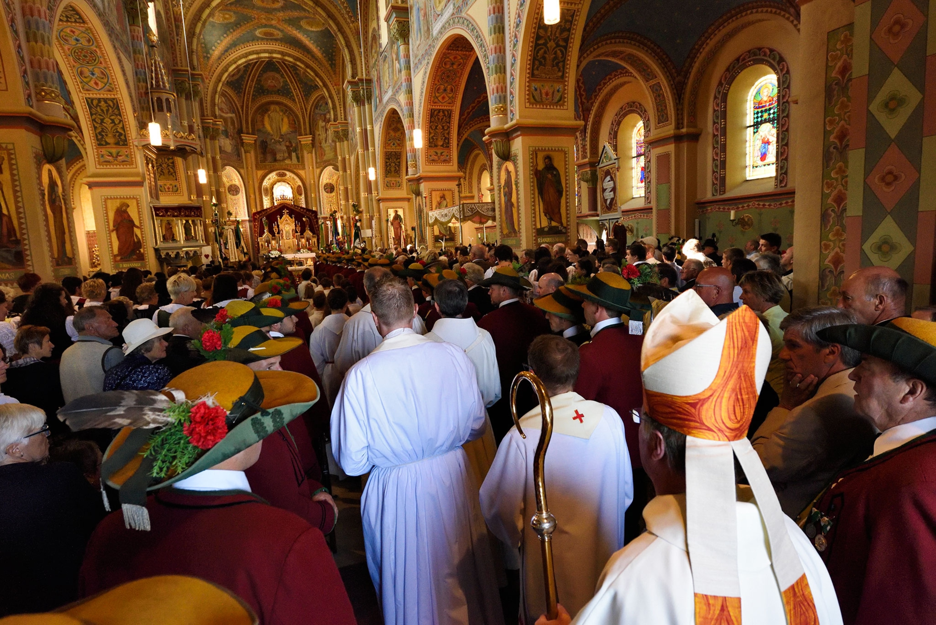people inside a church celebrating the Sacred Heart of Jesus fires