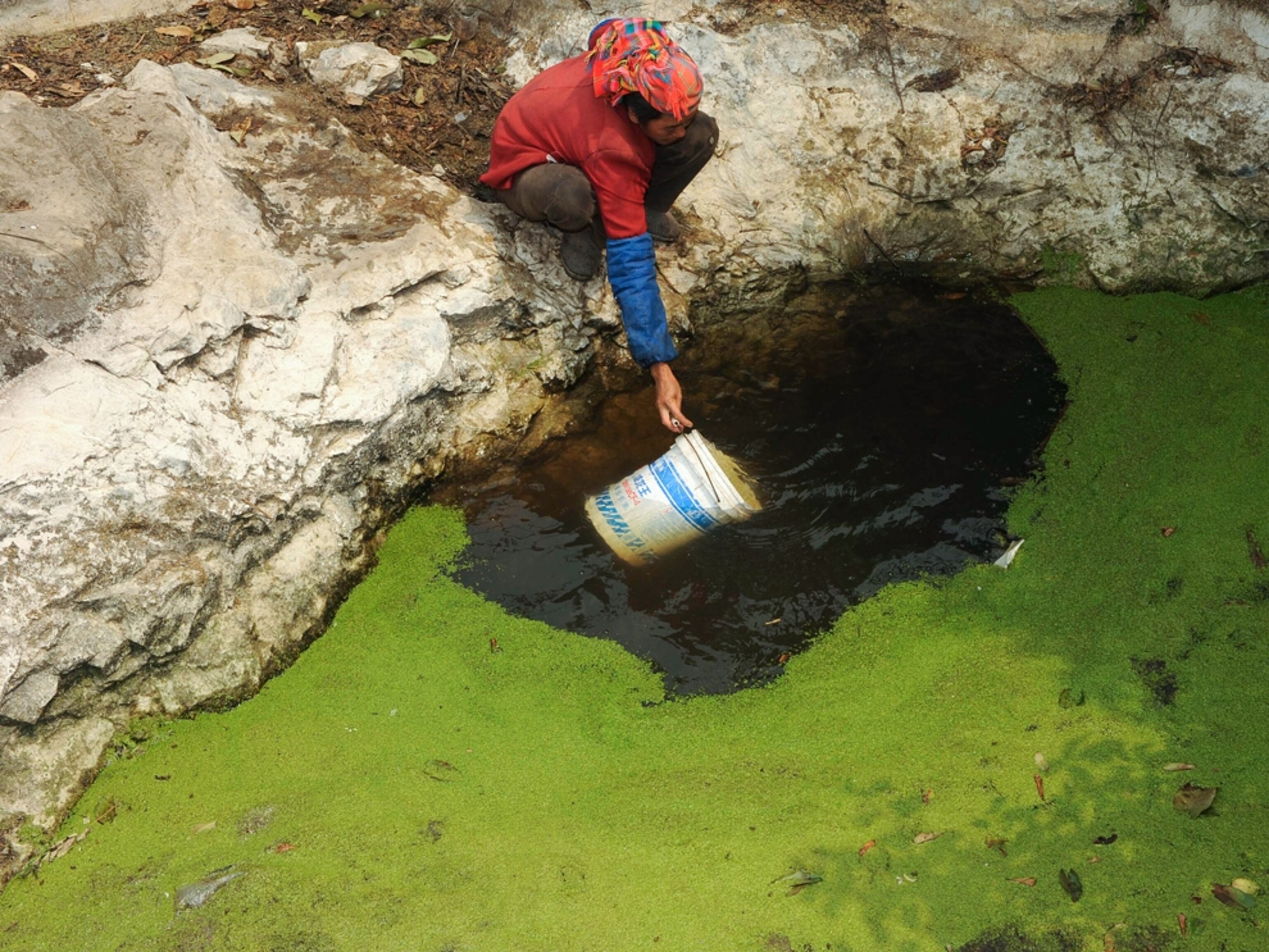 A man collects water from a well in China